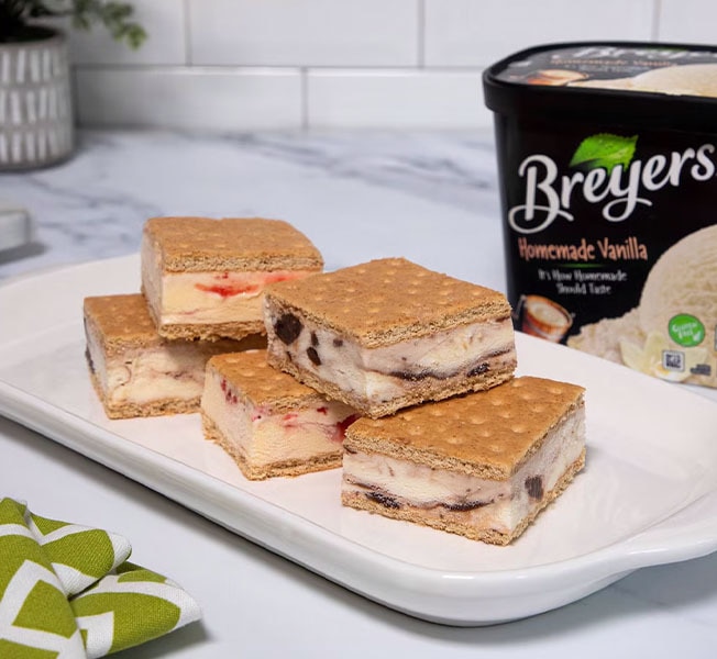 Graham cracker ice cream sandwiches with ice cream filling on a tray plate