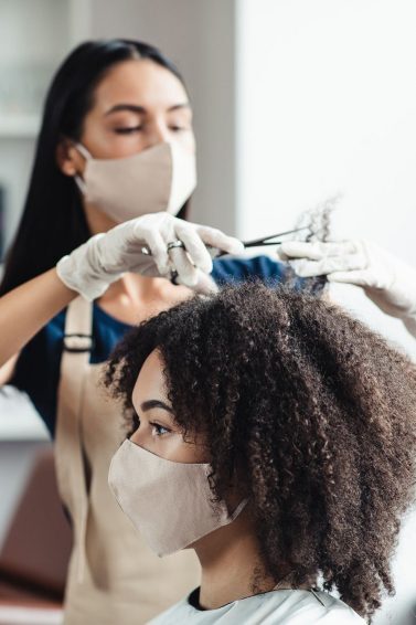 new year's resolutions: woman in a salon getting a her hair trimmed