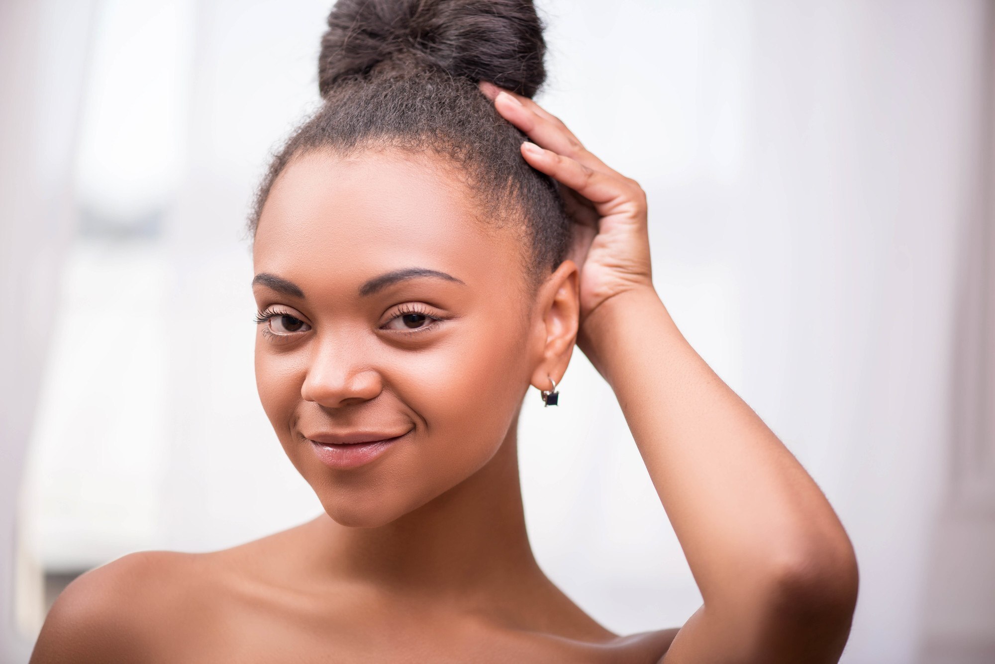 woman with a high topknot hiarstyle