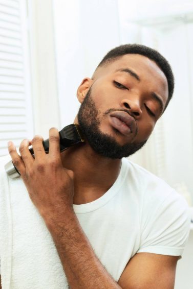 world beard day: man trimming his bear