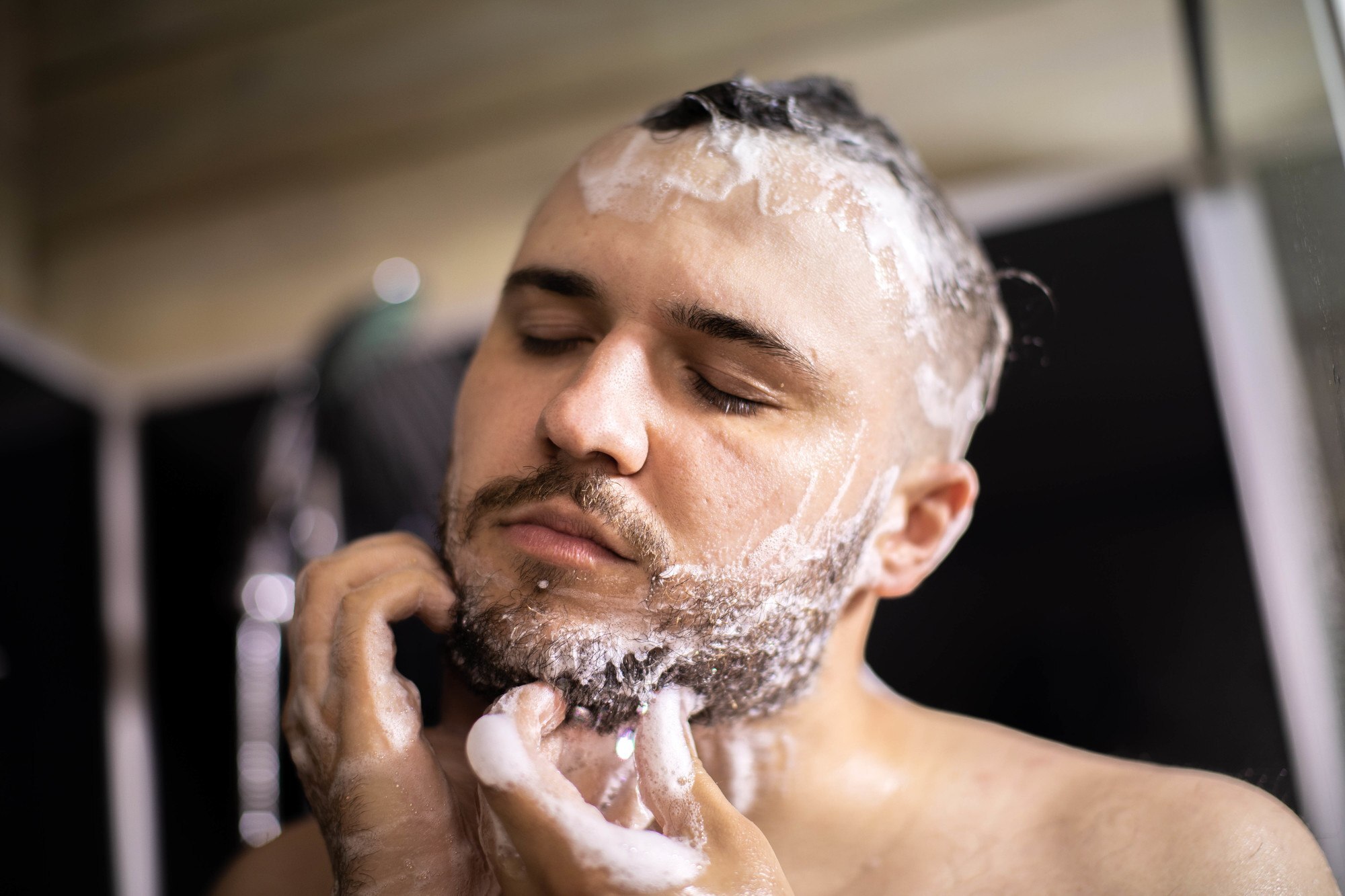 man washing his beard