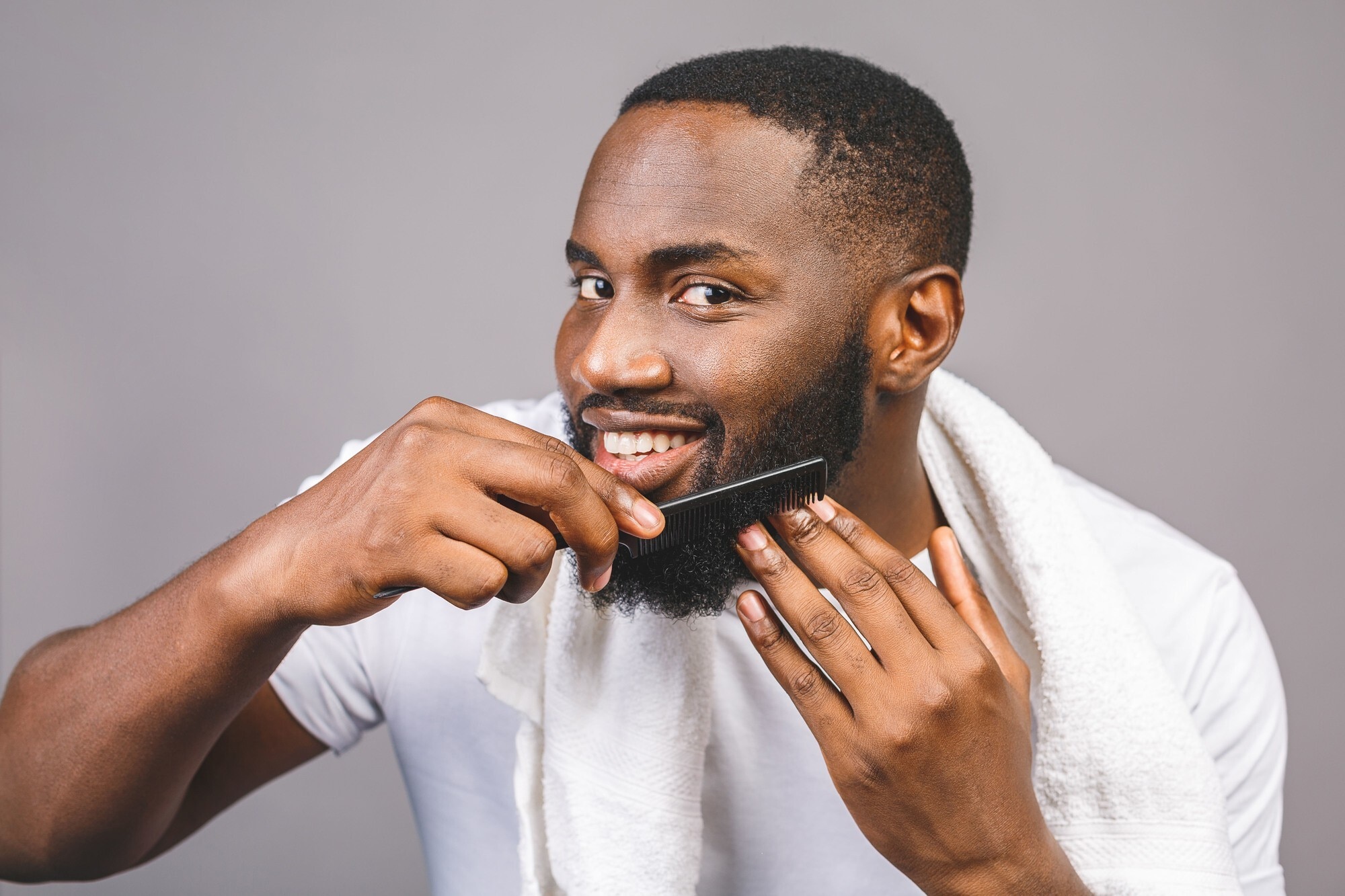 world beard day: man combing his beard