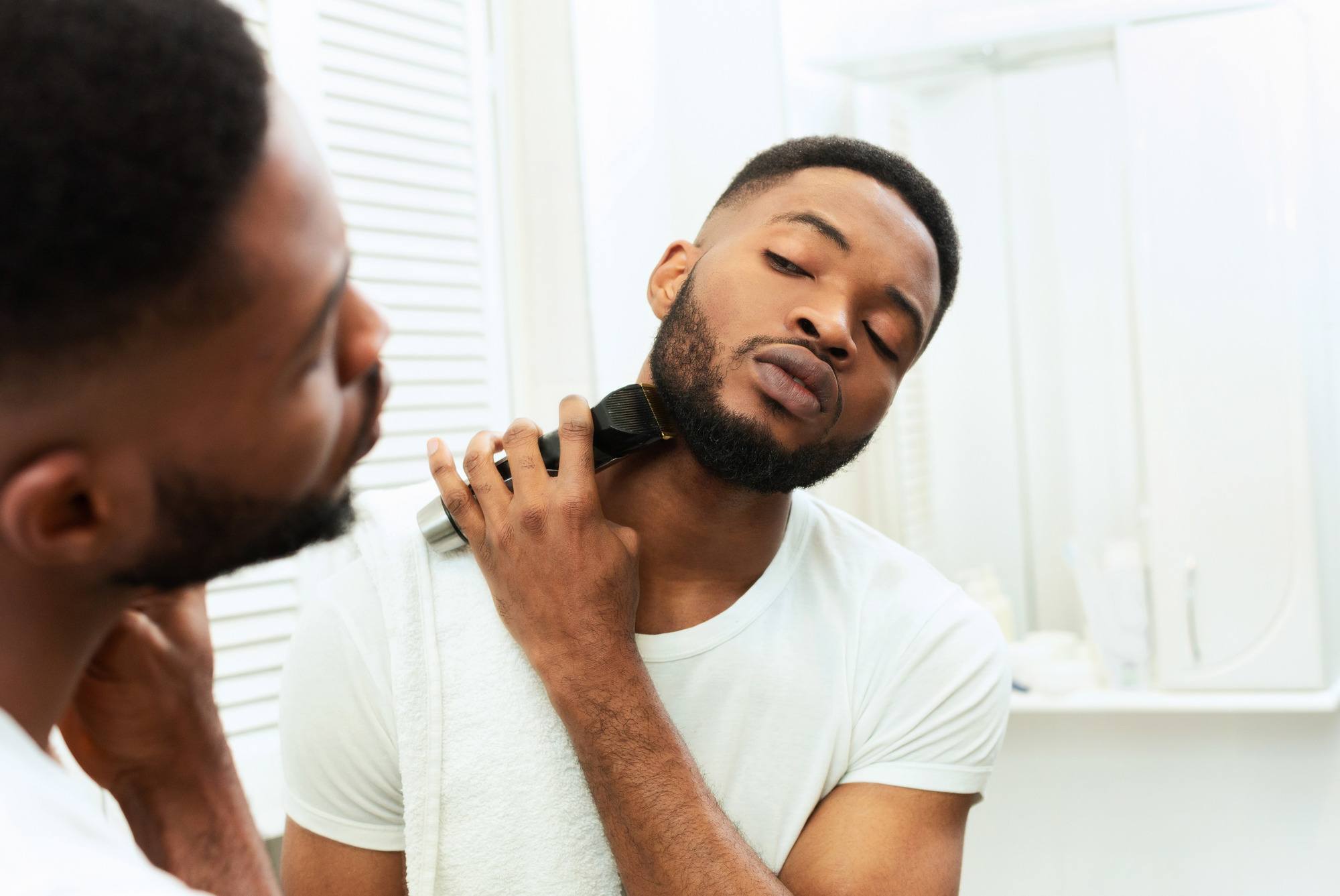 world beard day: man trimming his bear