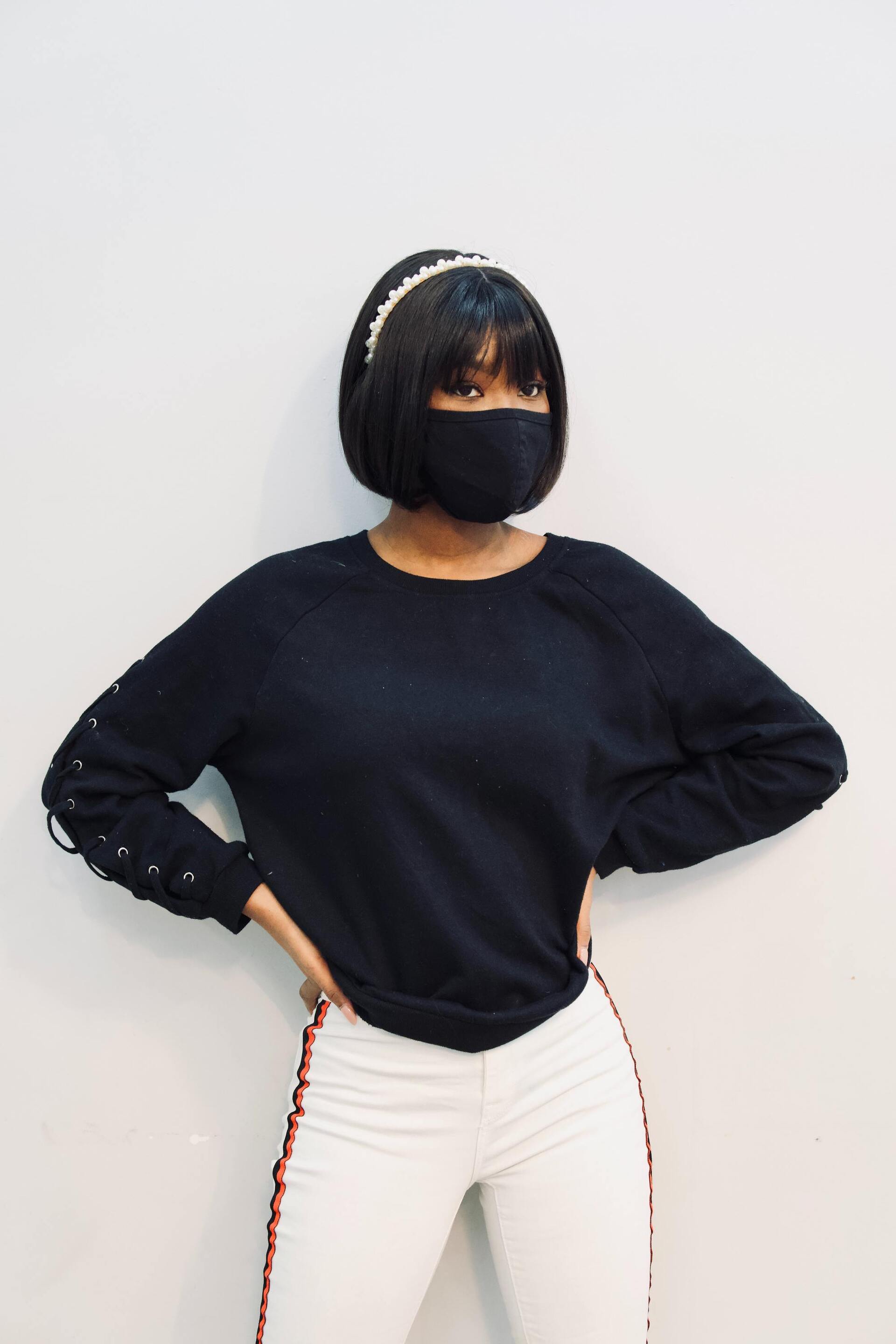 woman wearing a face mask, with a black bob hairstyle with a fringe and silver Alice band
