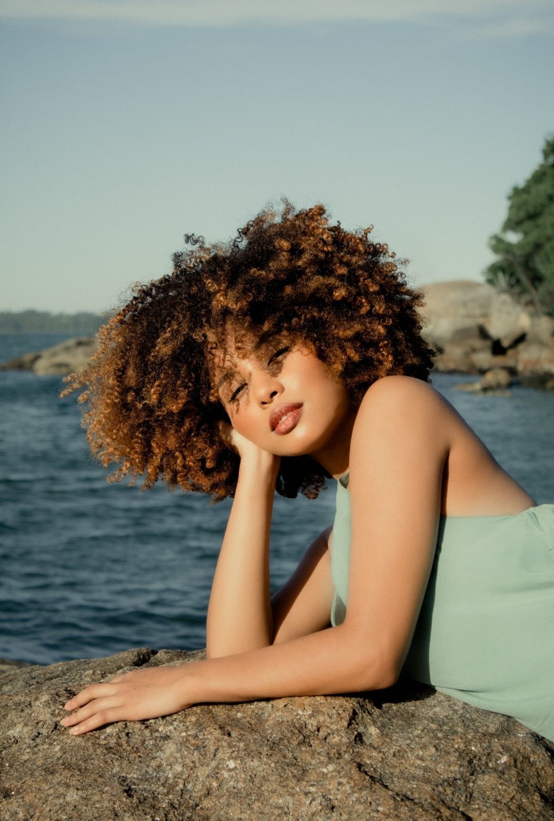 Woman with a curly afro and a fringe