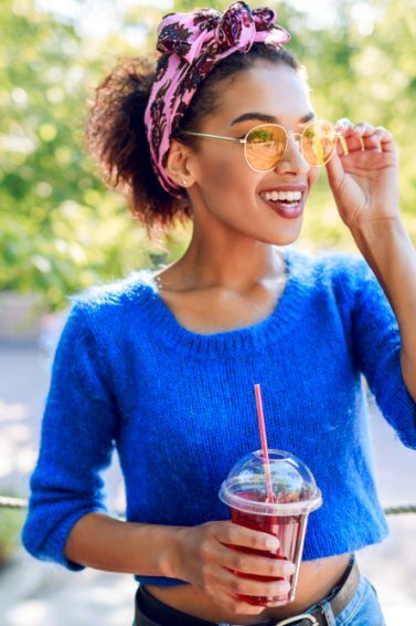 woman in blue shit short natural hair pink headband accessories