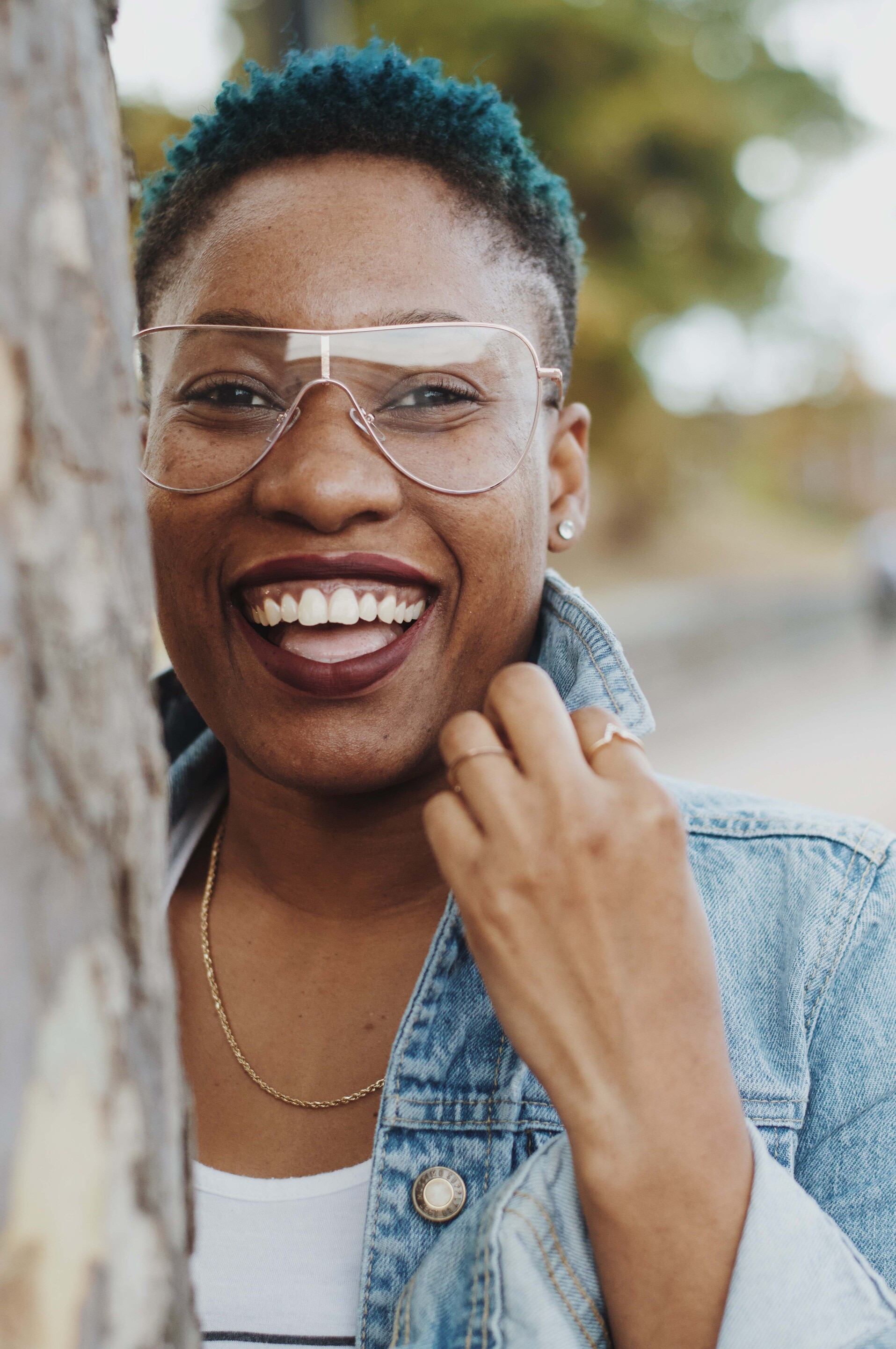 smiling woman blue natural hair short hairstyles twa