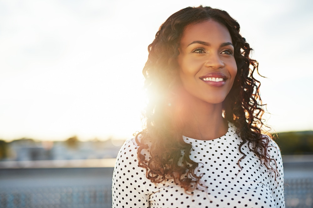 smiling woman chic curls natural hair