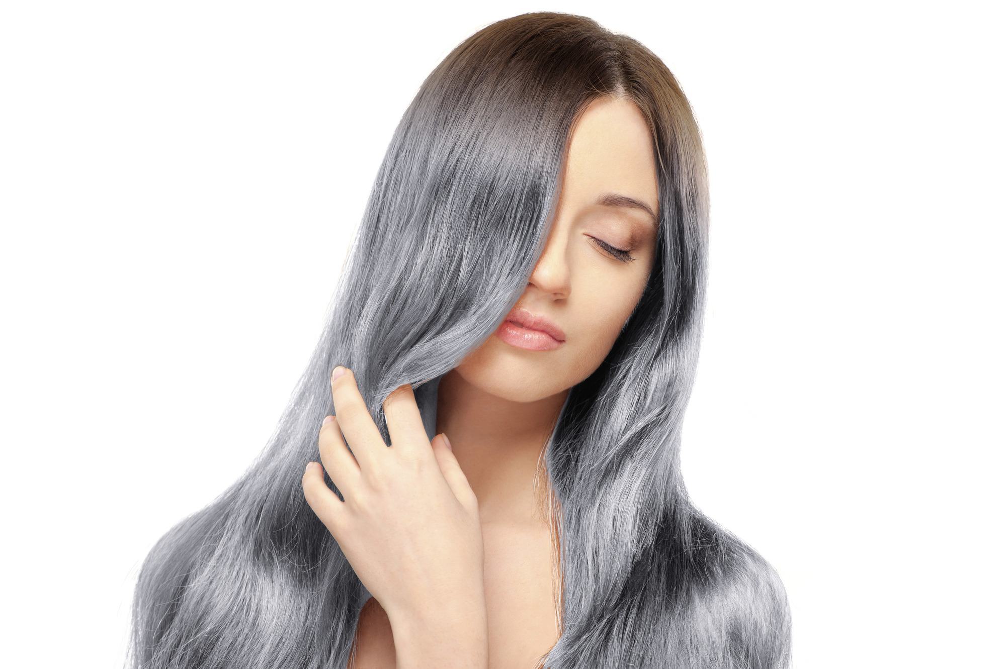 woman with long silver grey hair with dark roots