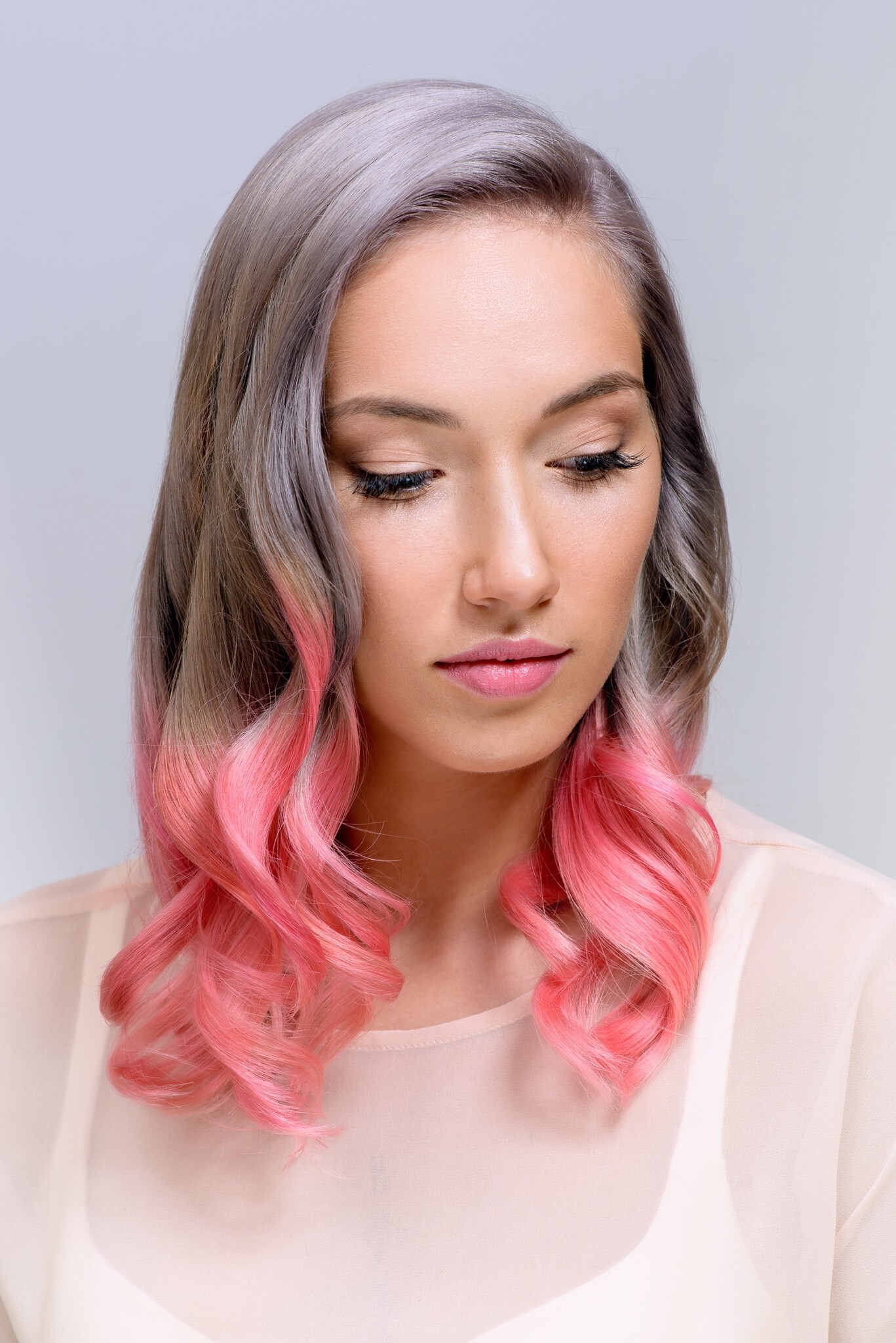 woman with medium length hair grey and pink ombre
