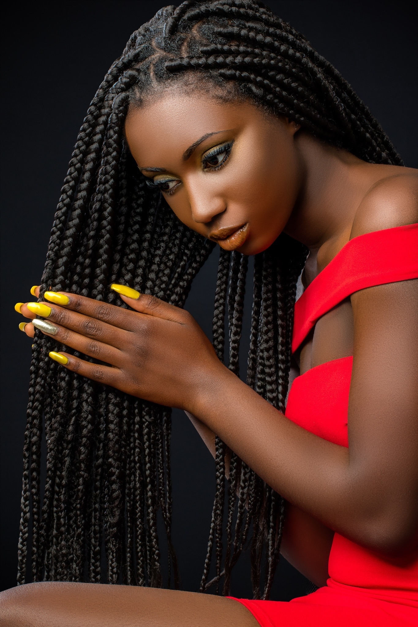 NYE party hairstyle: woman wearing long braids