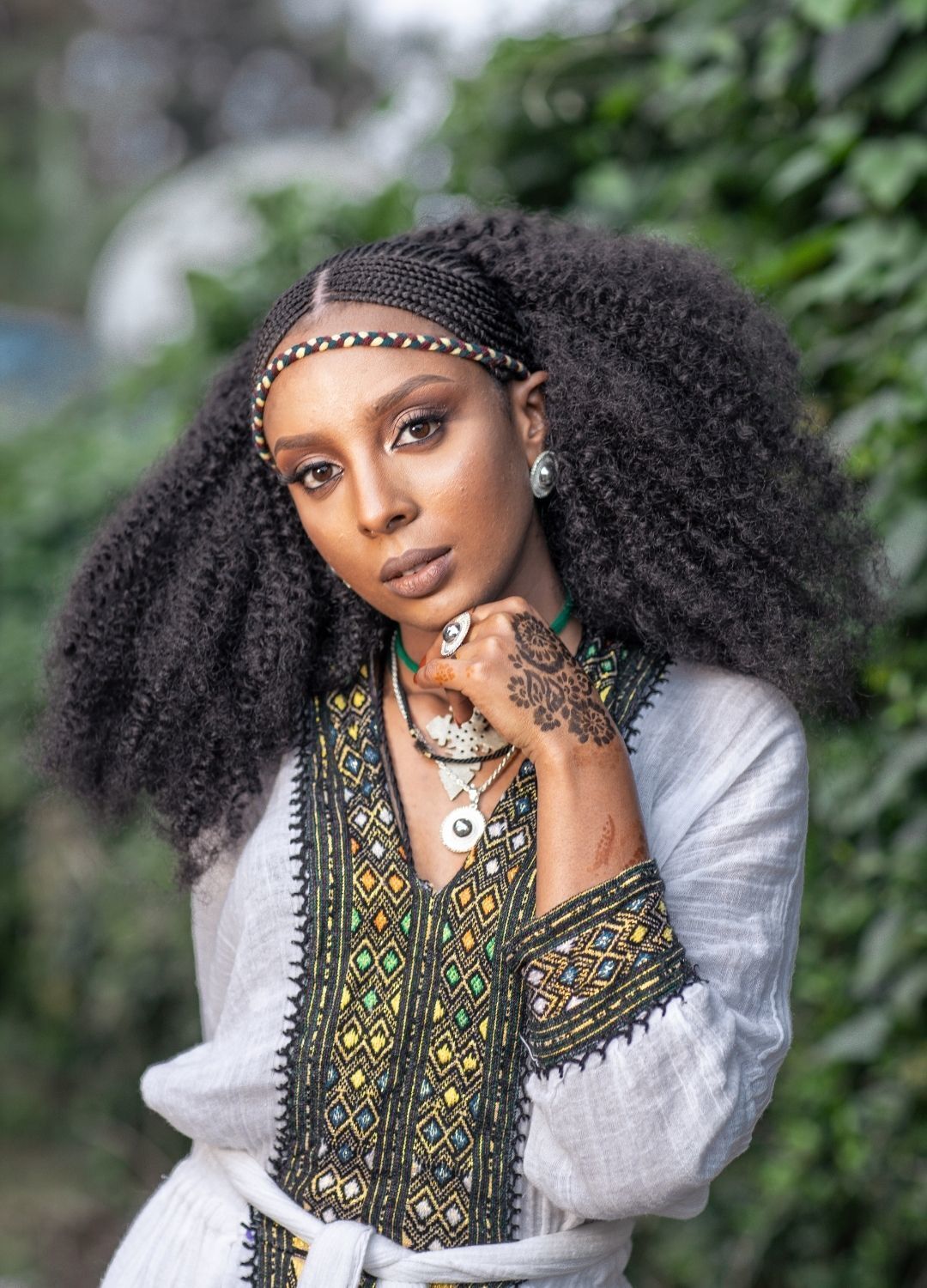 half braided hairstyles: woman with Fulani braids and her long natural afro