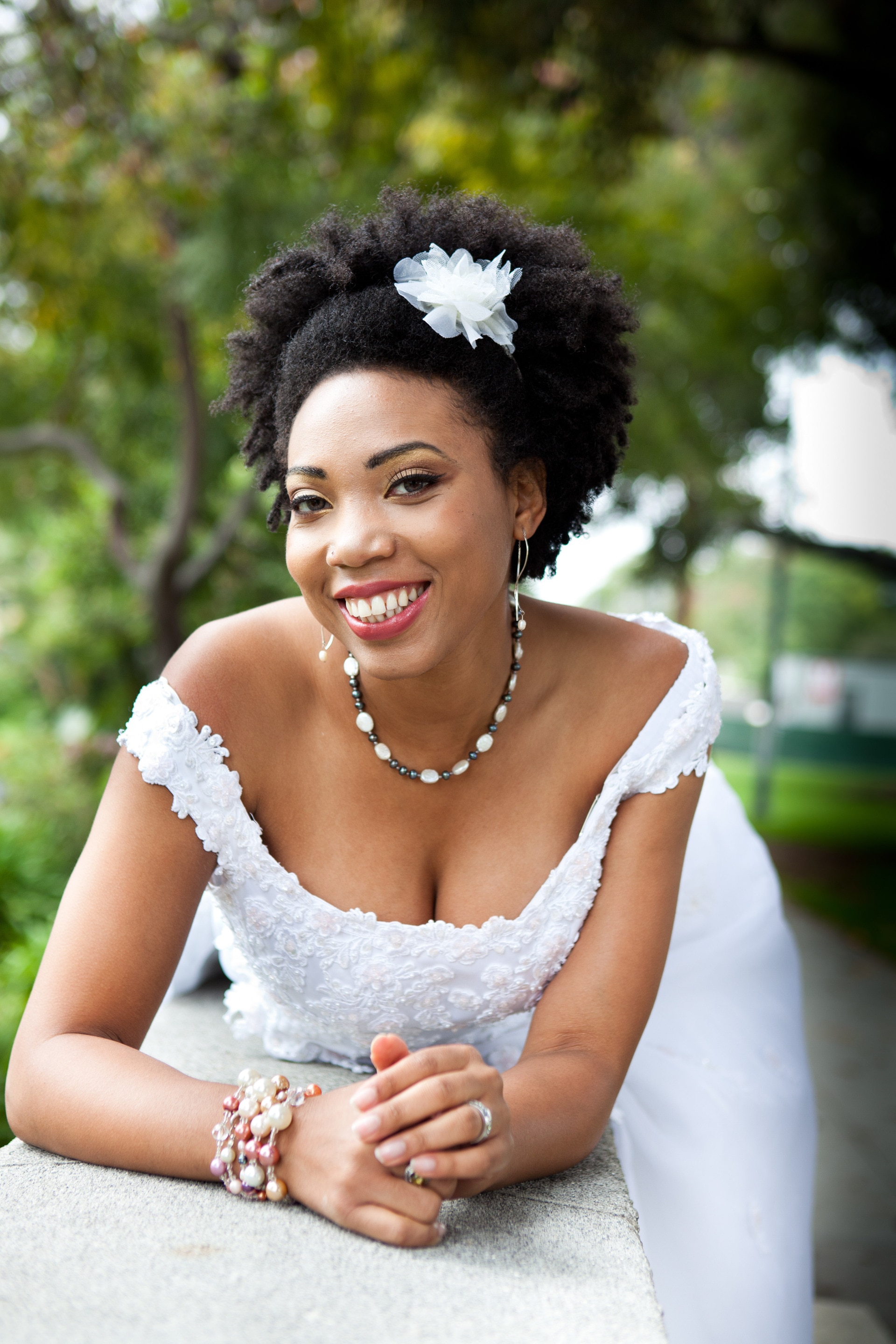 natural hair afro wedding hairstyle with flower accessory