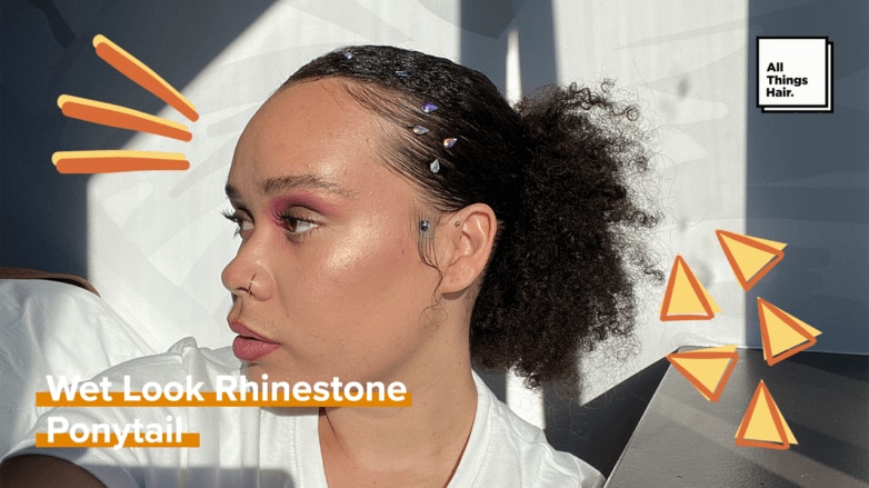 woman with slicked back, wet look curly ponytail and rhinestones