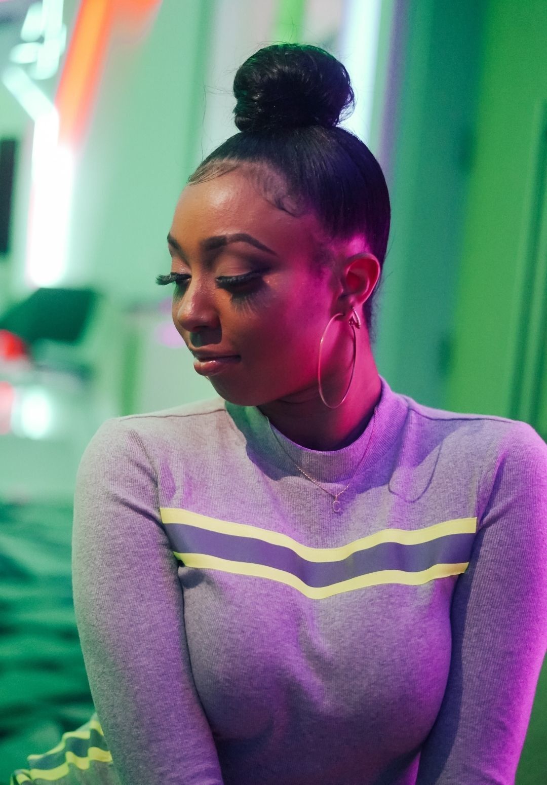 woman with her hair slicked into a neat high bun