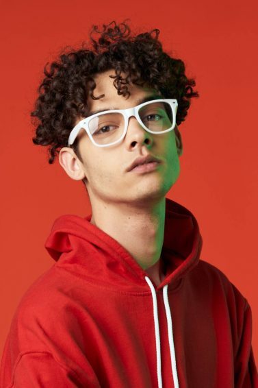 man with glasses and short curly hair