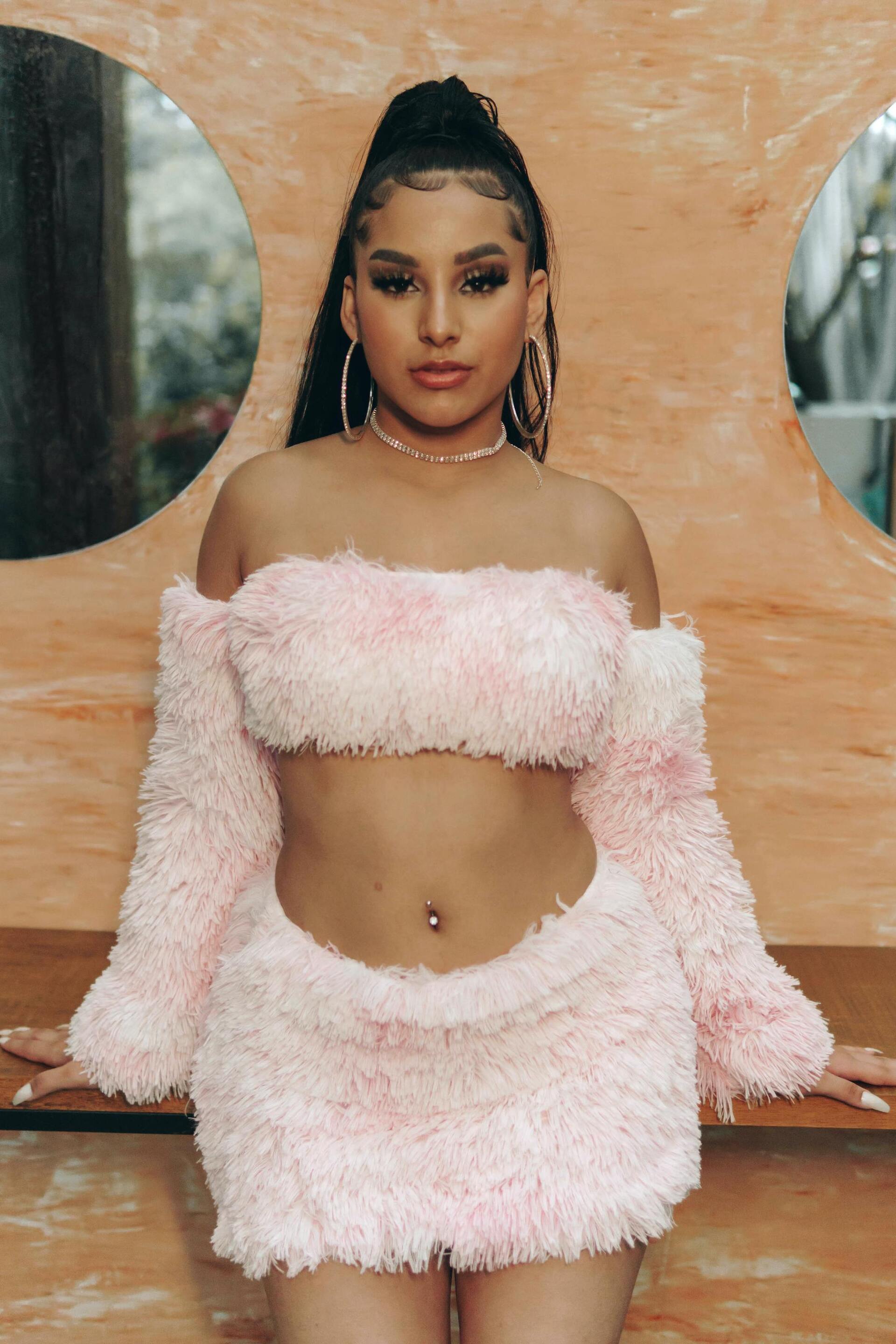 Euphoria hairstyles: woman with her hair tied into a slick high ponytail with neatly brushed and gelled baby hairs