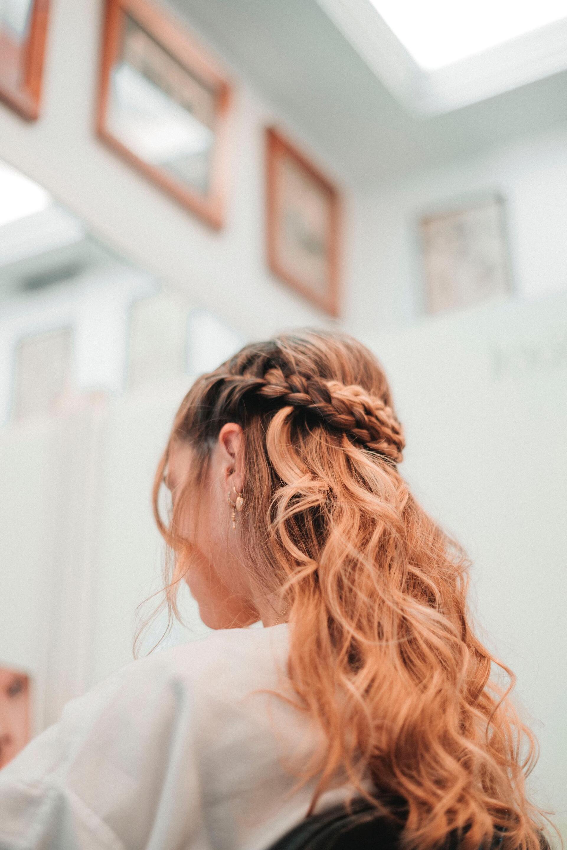 wavy strawberry blonde hair with a half halo braid