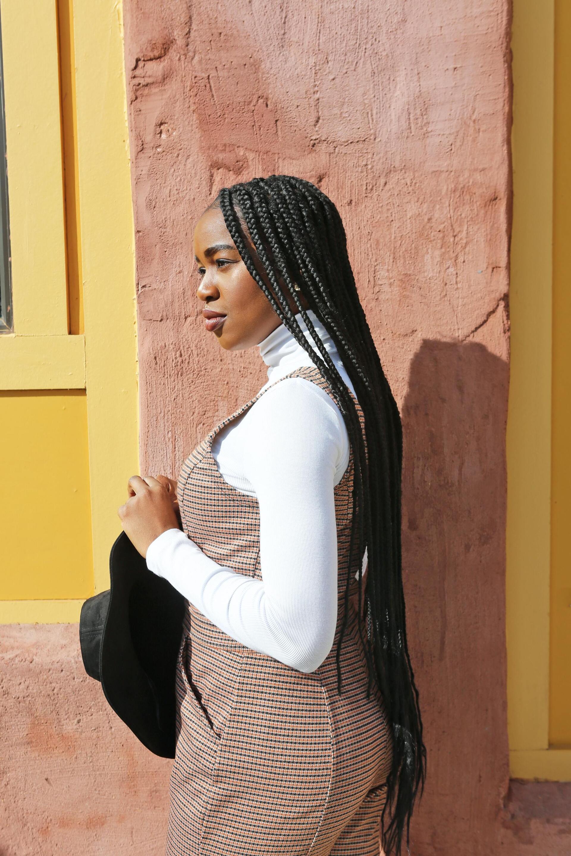 Euphoria hairstyles: woman with very long single braids