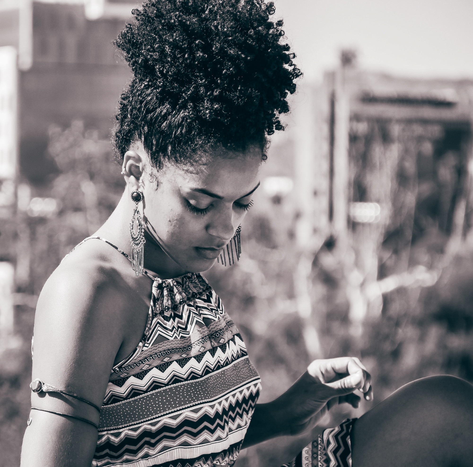 woman with her curly afro hair in a high puff hairstyle