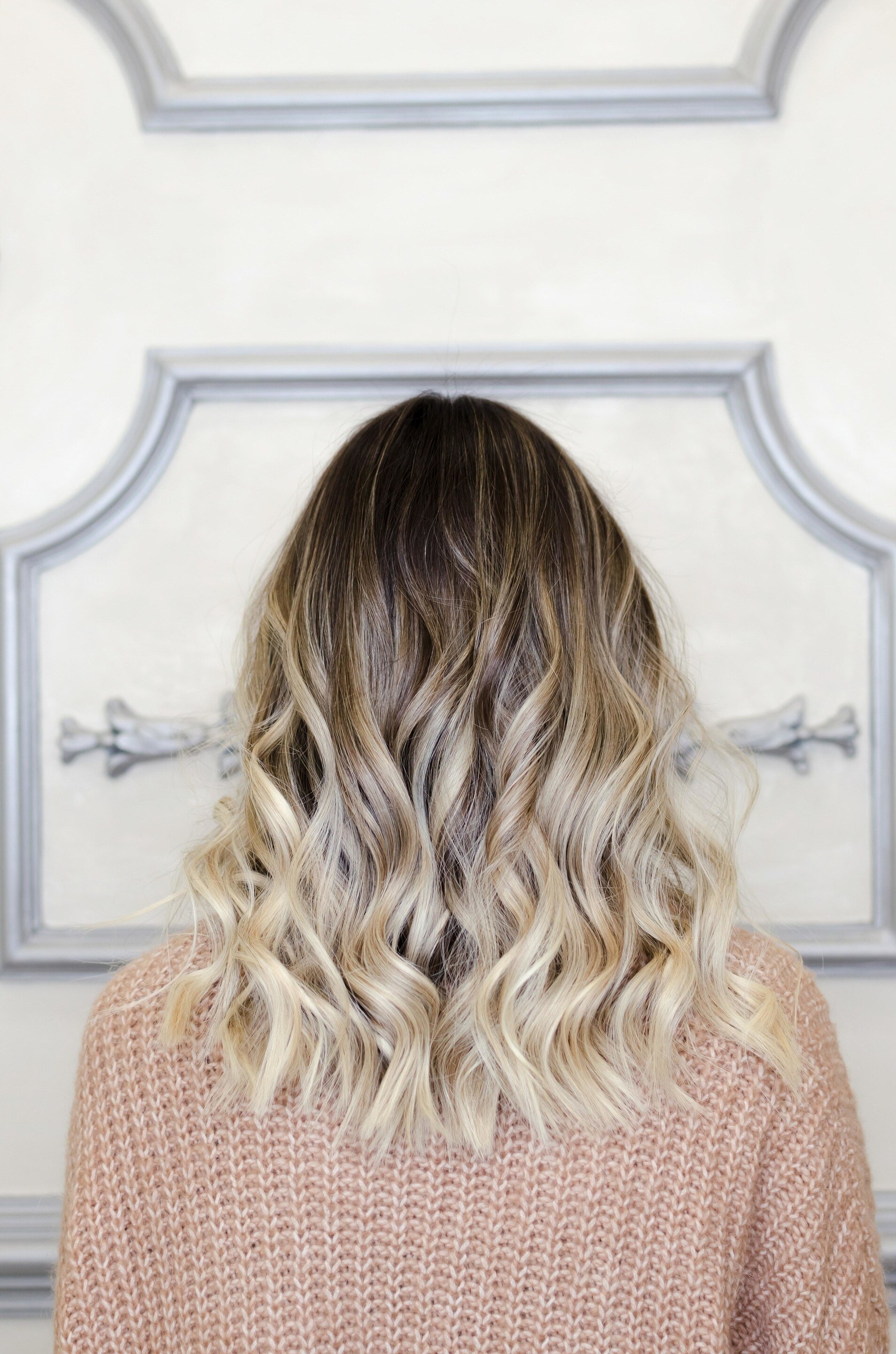 woman with dark roots and blonde balayage
