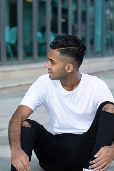 man with neat hair, fade hairstyle and side path