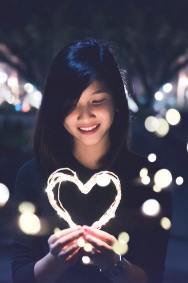 mental health: woman holding a wire frame heart light-shaped