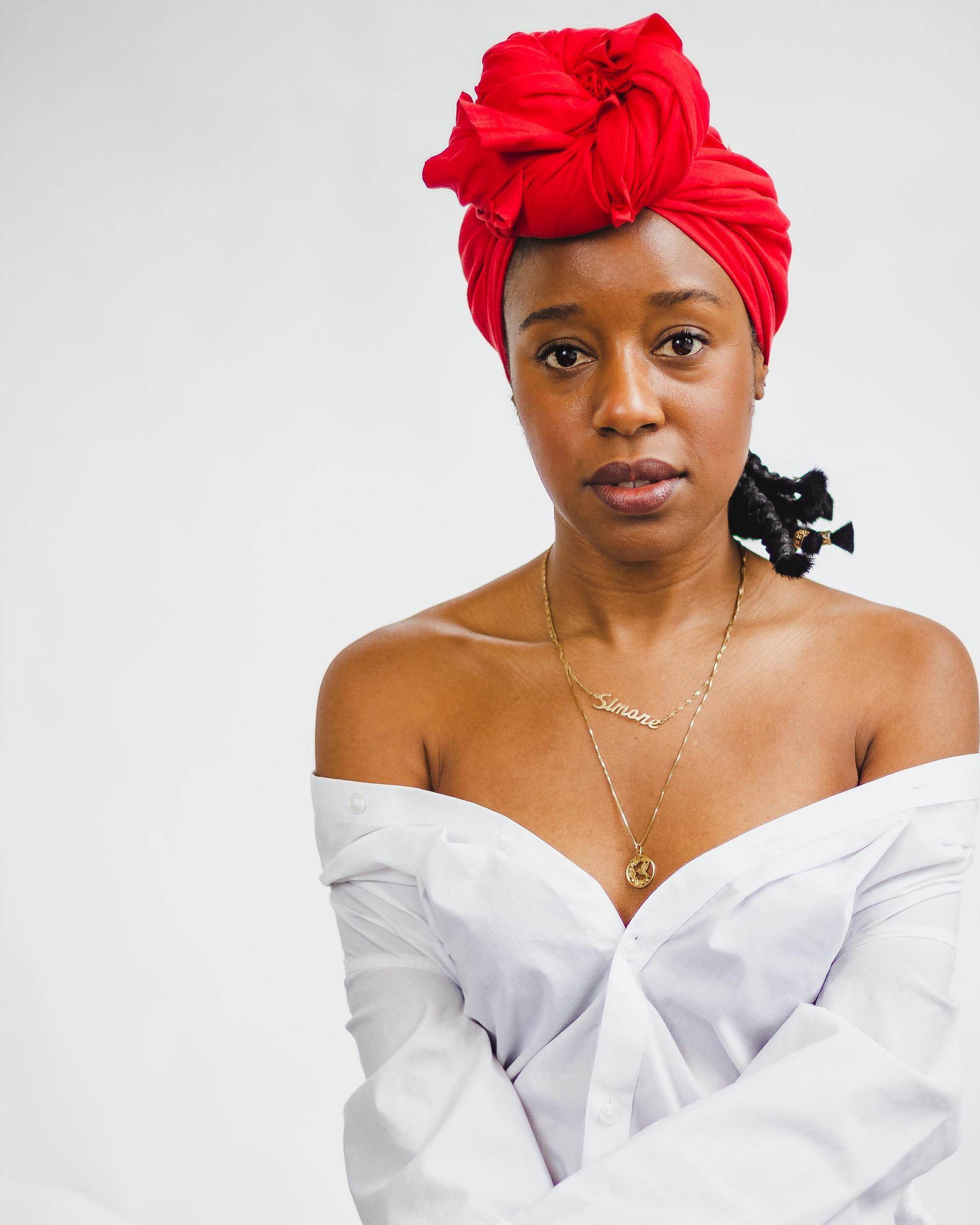 Woman wearing a red headscarf for a kitchen-friendly hairstyle