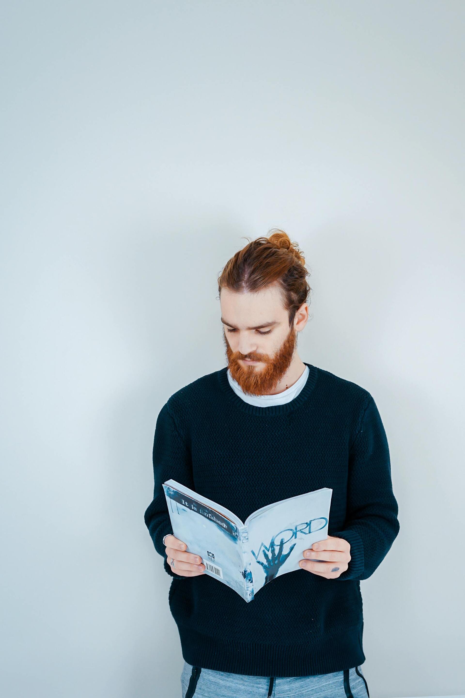 Man with ginger hair wearing a man bun as a kitchen hairstyle