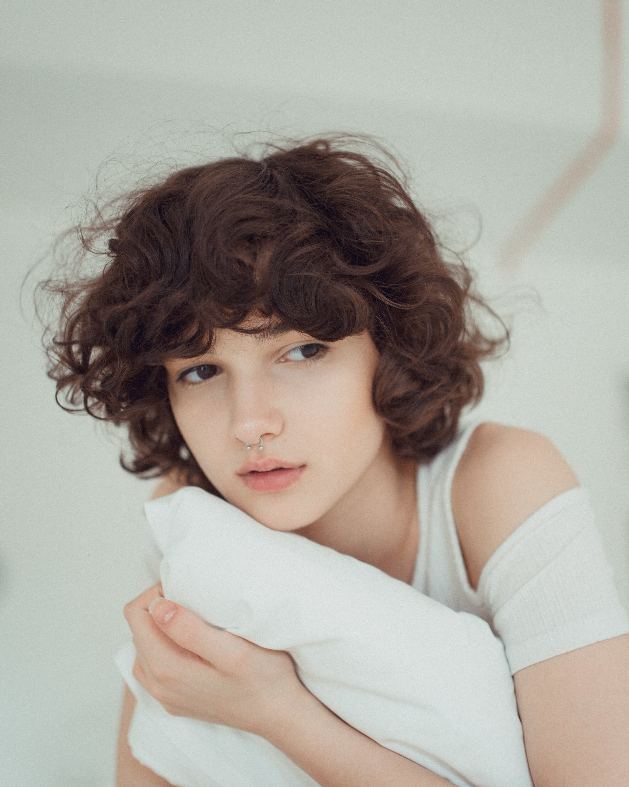 permed hairstyles: woman with short, loosely curled brown hair