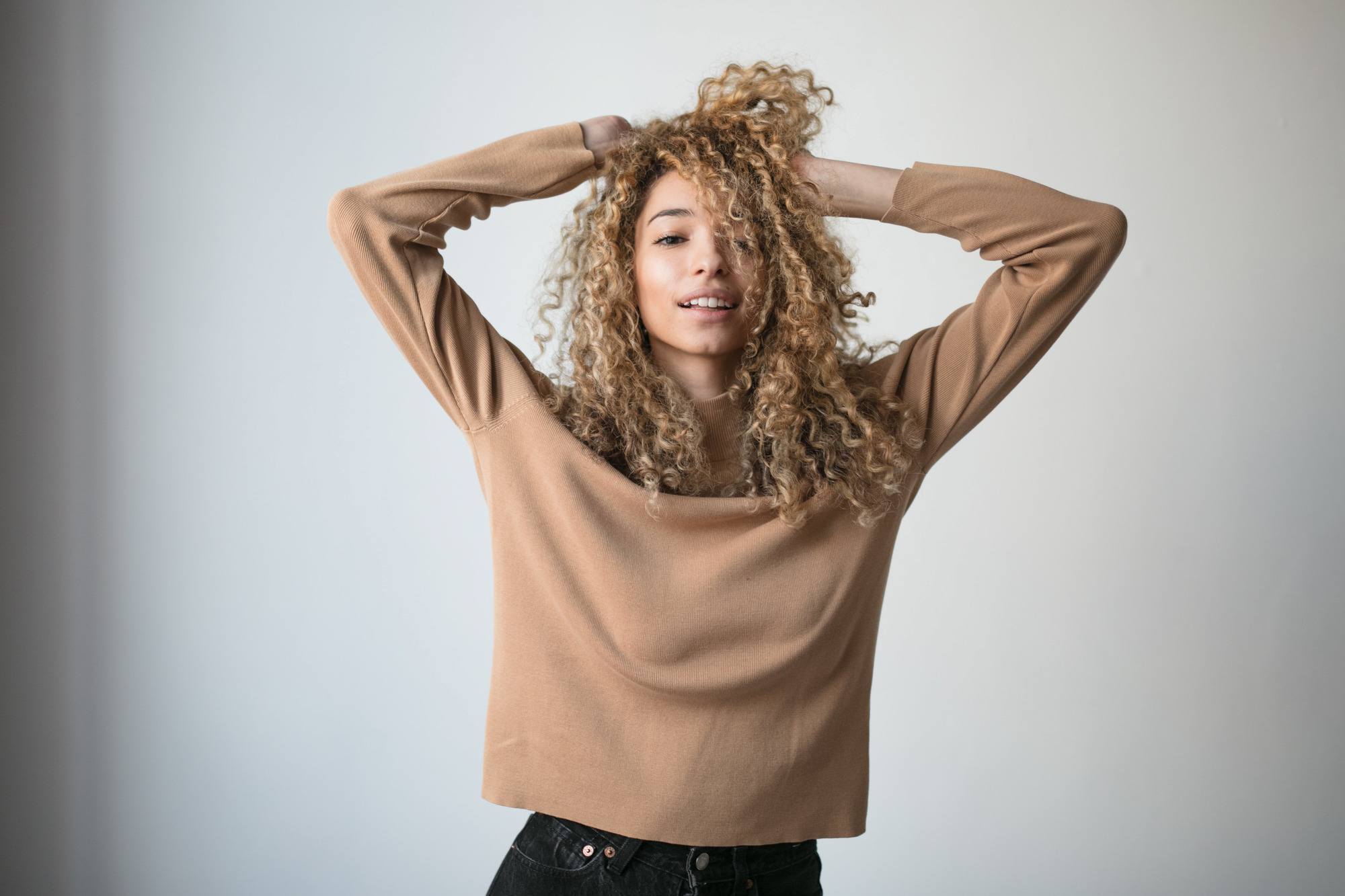 permed hairstyle: woman with blondish brown curly hair