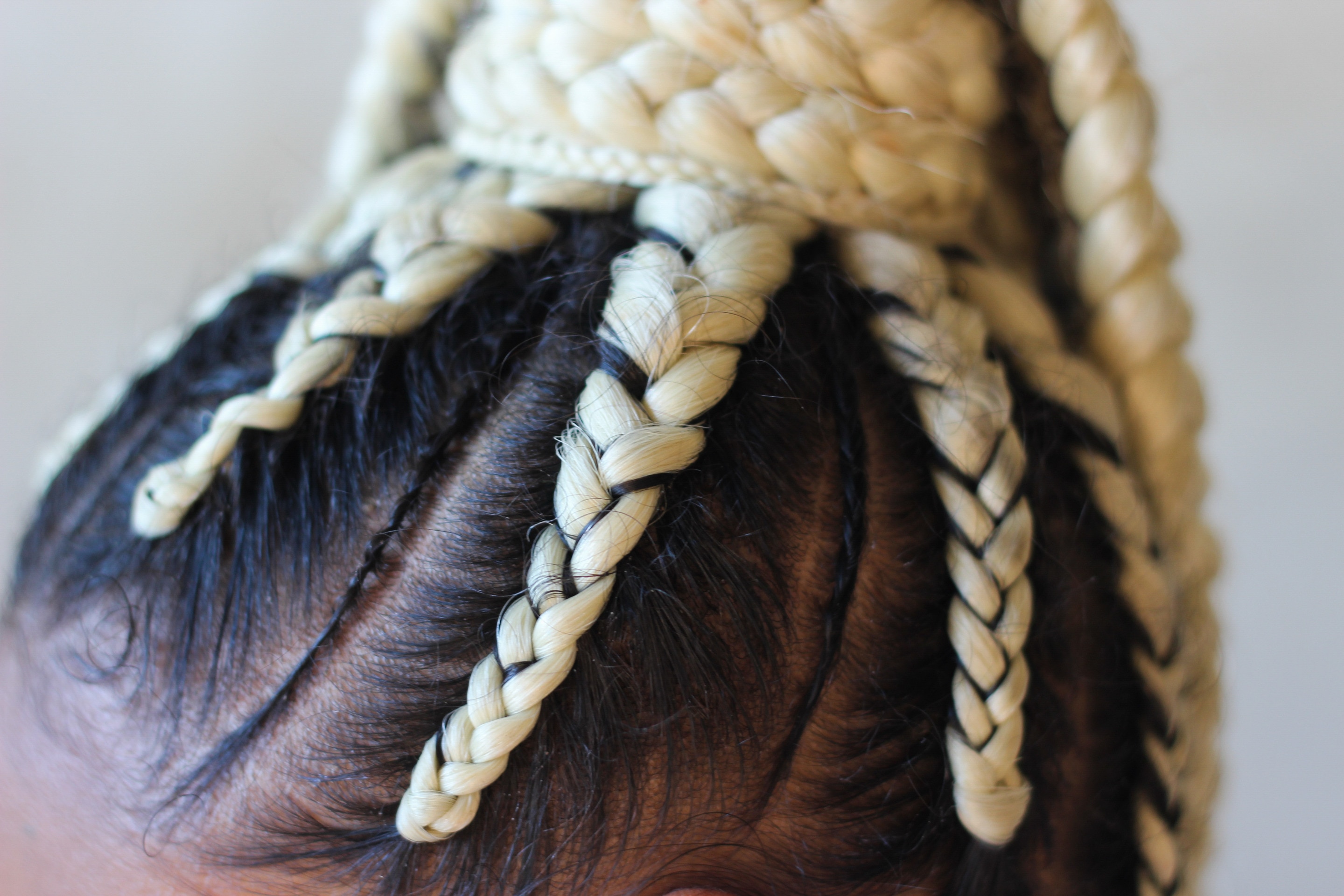 closeup shot black and blonde cornrow braids