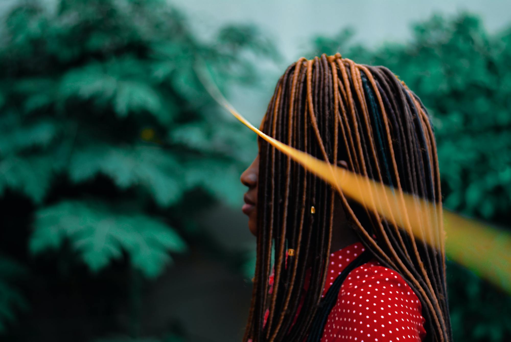 woman with long black and brown faux locs