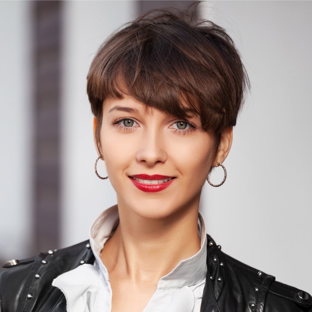 woman with short pixie cut cut with a side part graduation hairstyle
