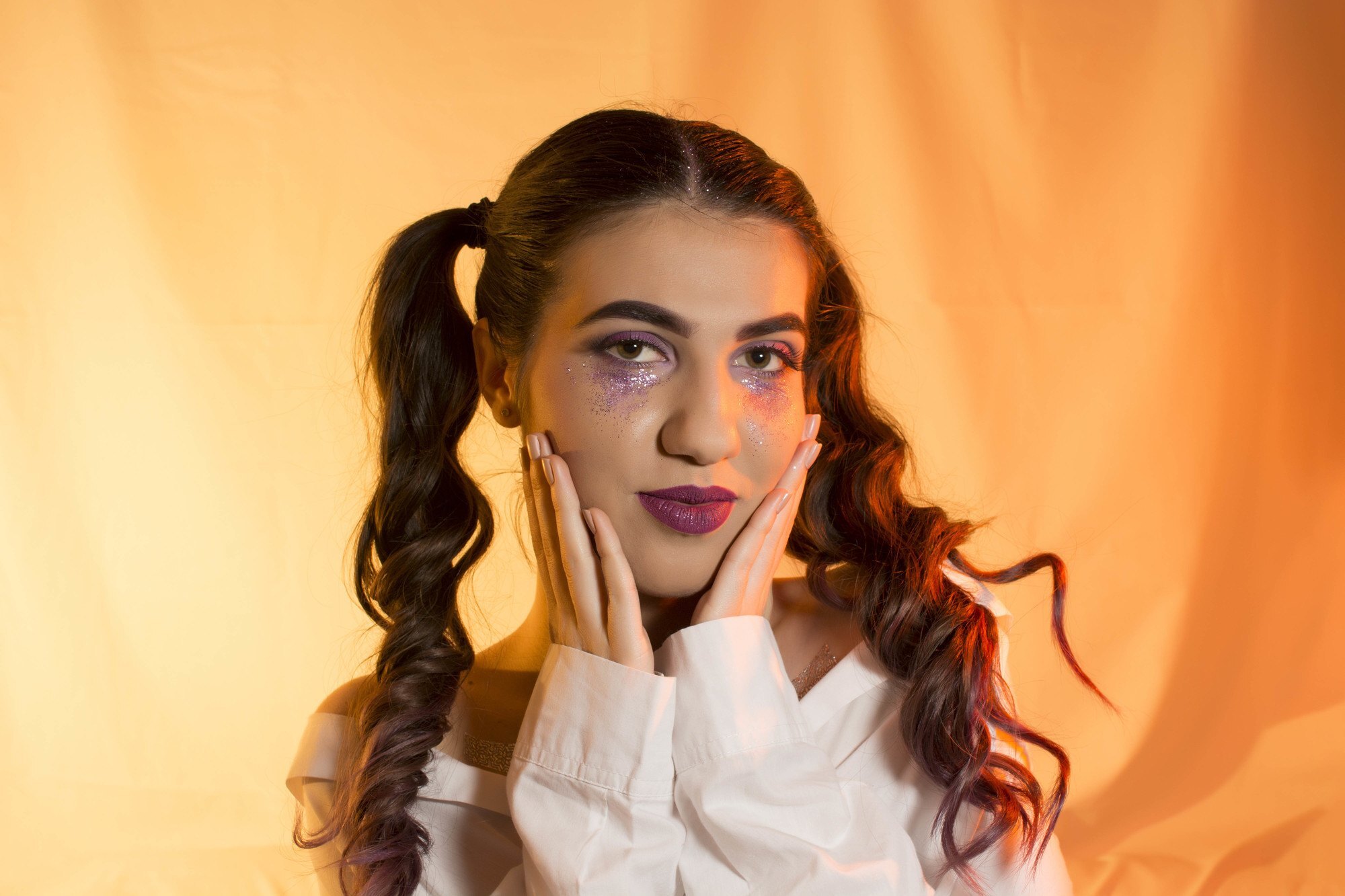 Woman with two curly ponytails