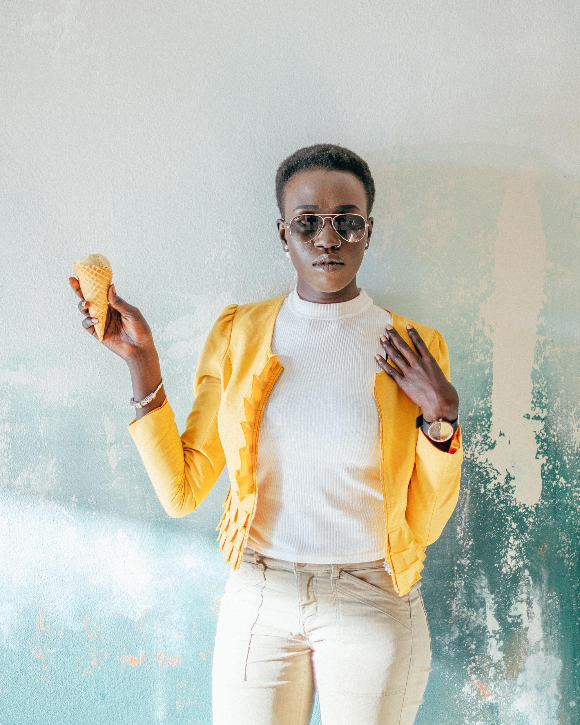 woman with a bright yellow cardigan and short afro hairstyle