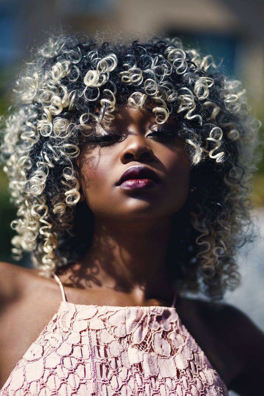 dark skinned girl with ash blonde hair dark roots curly hair natural hair