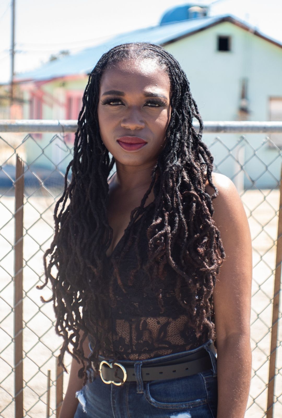 spring-worthy hairstyles: woman with long locs that are pinned back