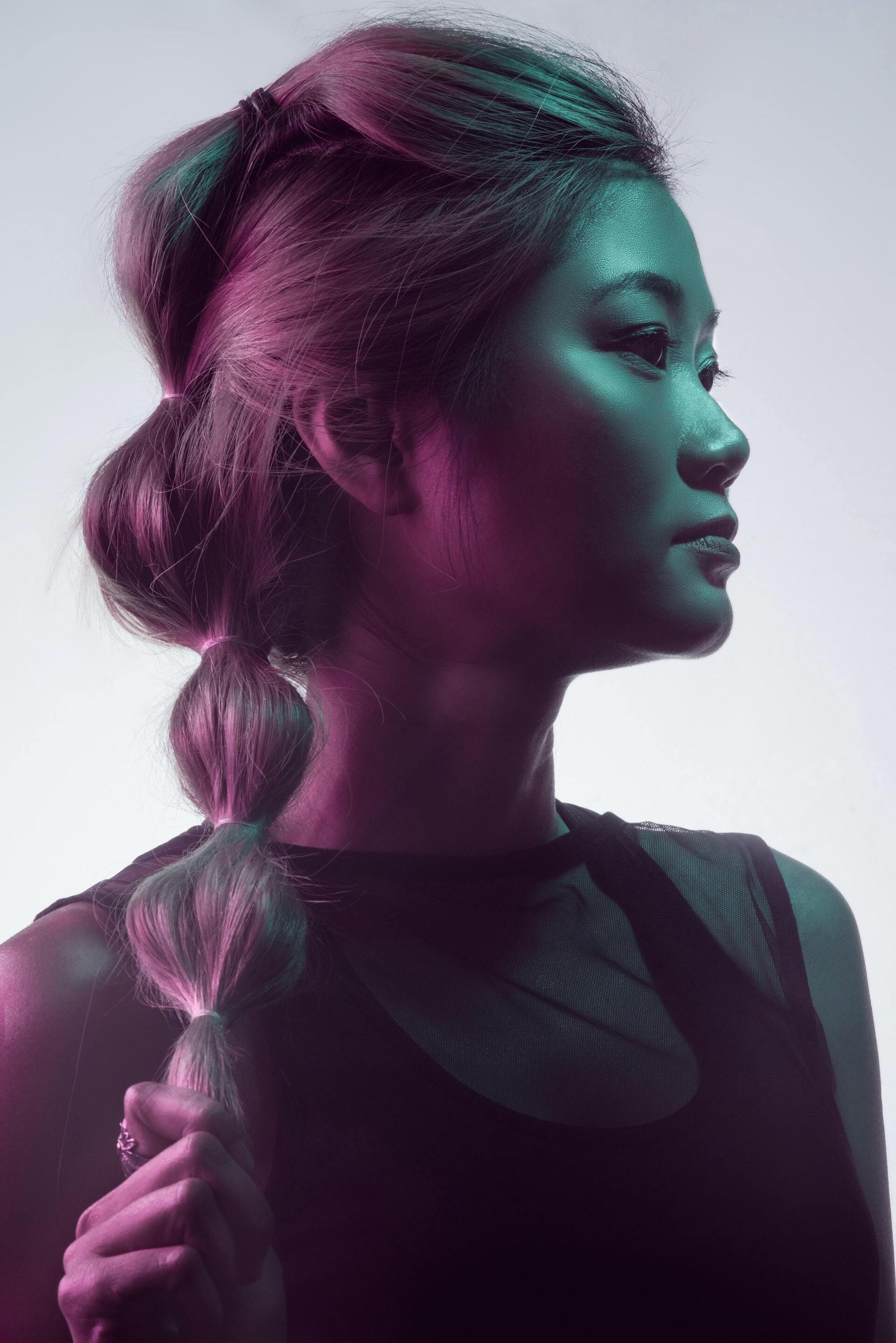 woman with long hair tied in a ponytail with many hair ties