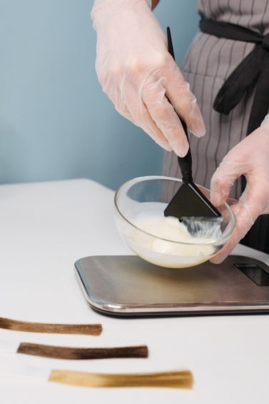 dye your hair at home: three swatches of hair and a mixing bowl with hair dye being mixed
