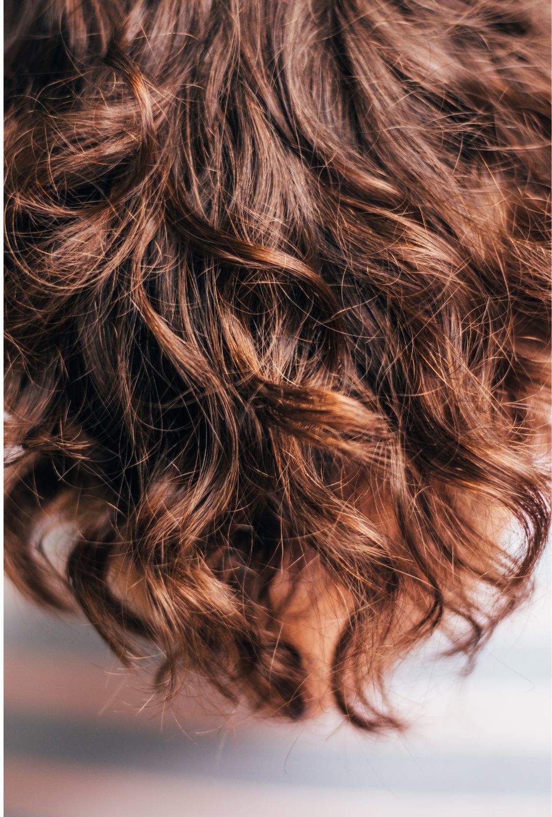 dye your hair at home: close-up image of brown wavy hair