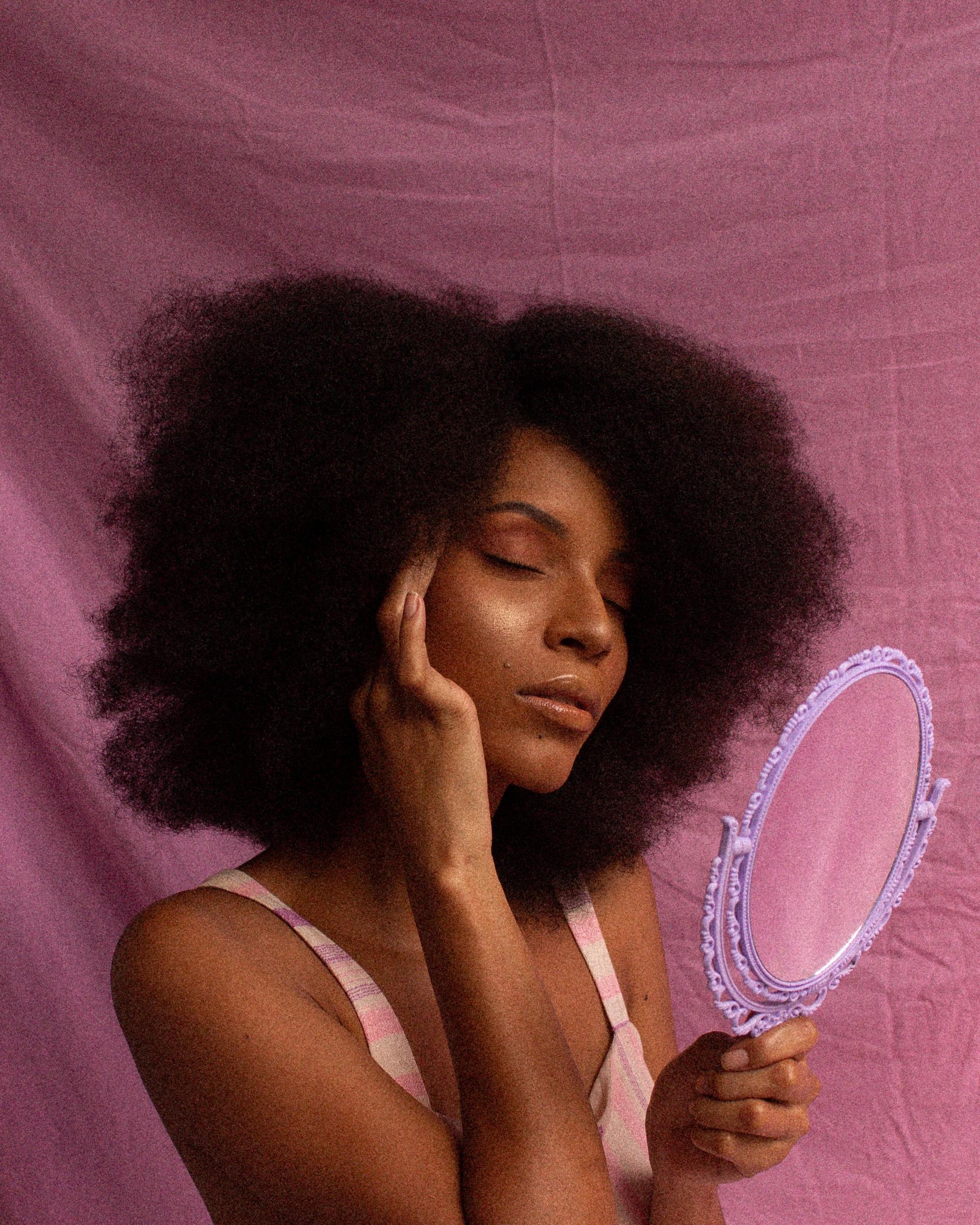 dye your hair at home: woman looking into a mirror