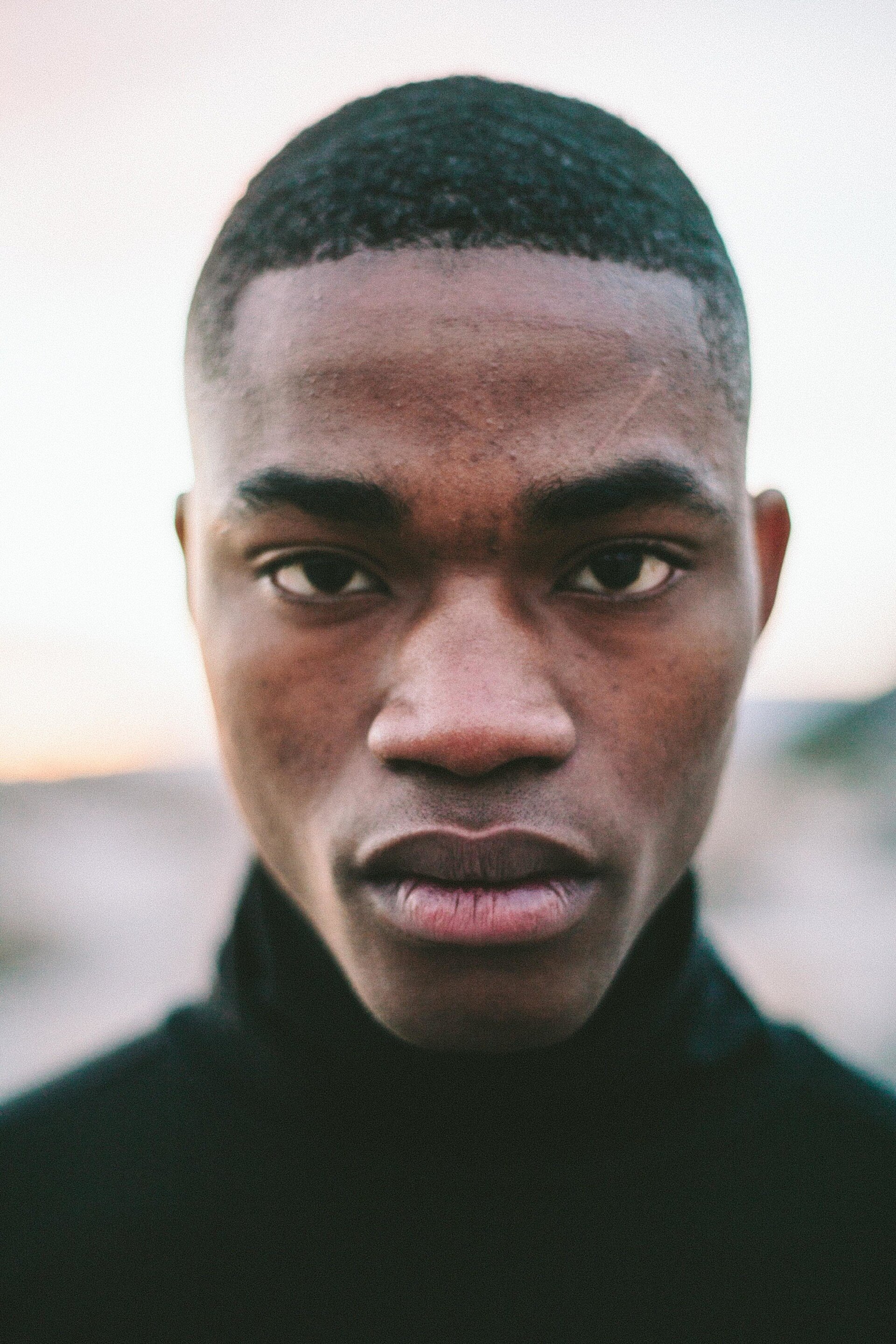 man with buzz cut hairstyle and a fade