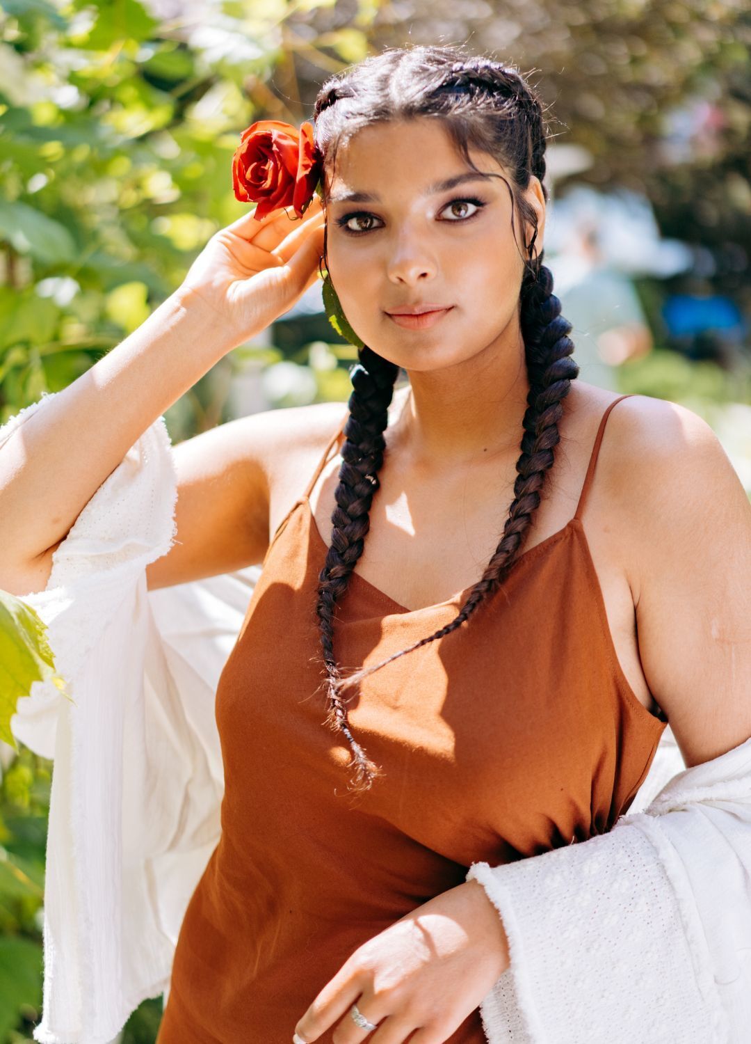 woman with long brown hair, braided into two plaits