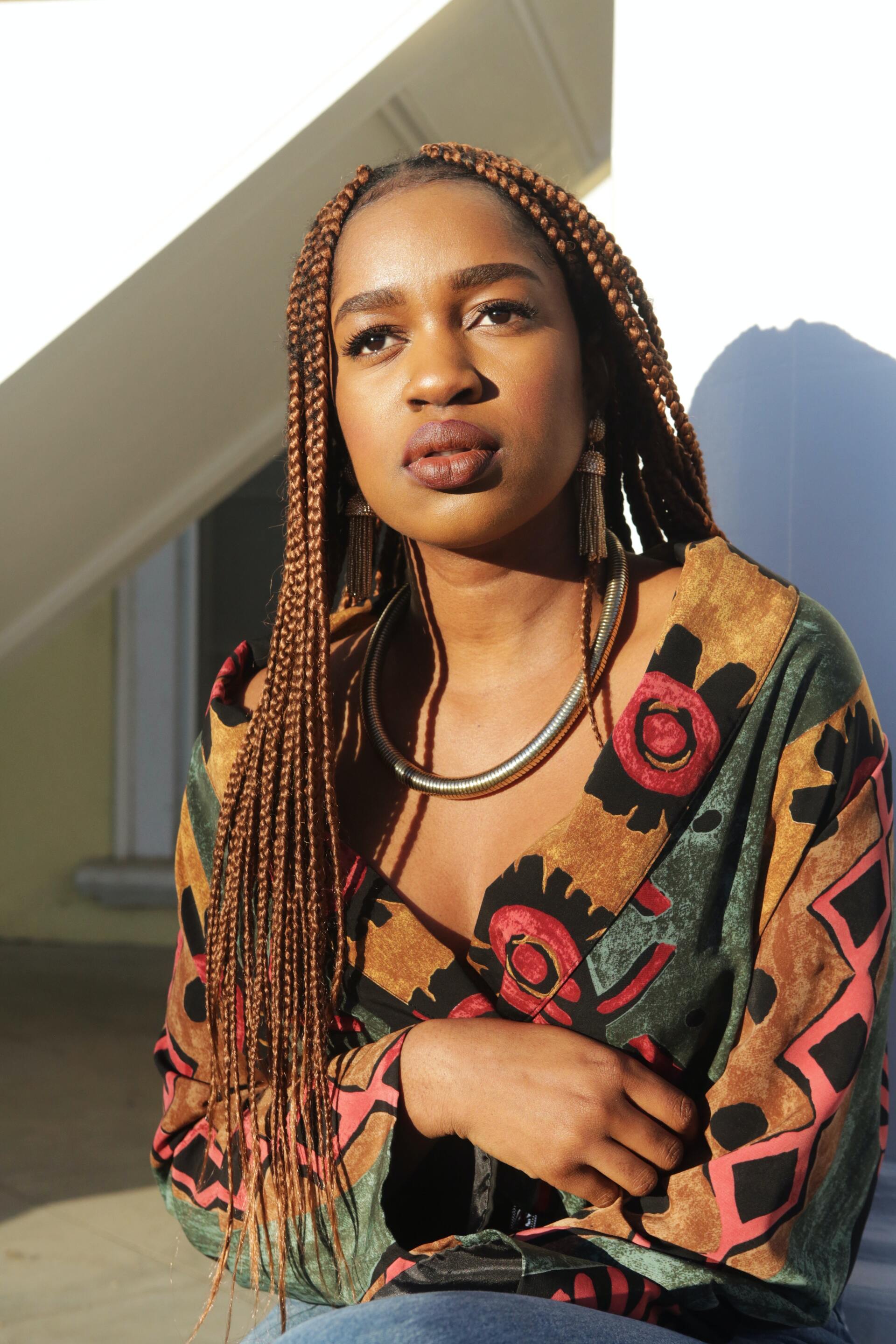 hair colour inspiration: woman with thin braids that are warm brown in colour