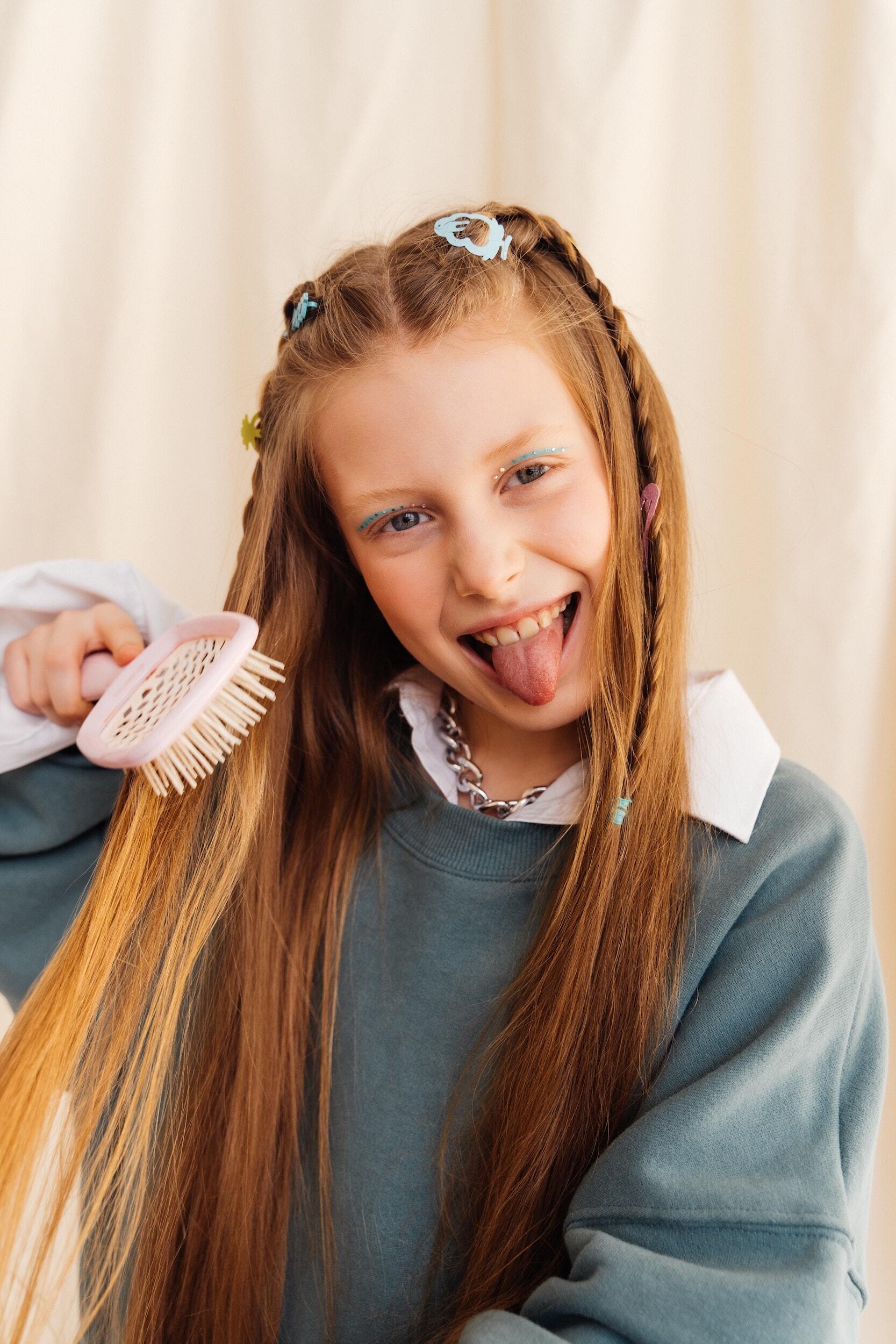 Little girl brushing her hair