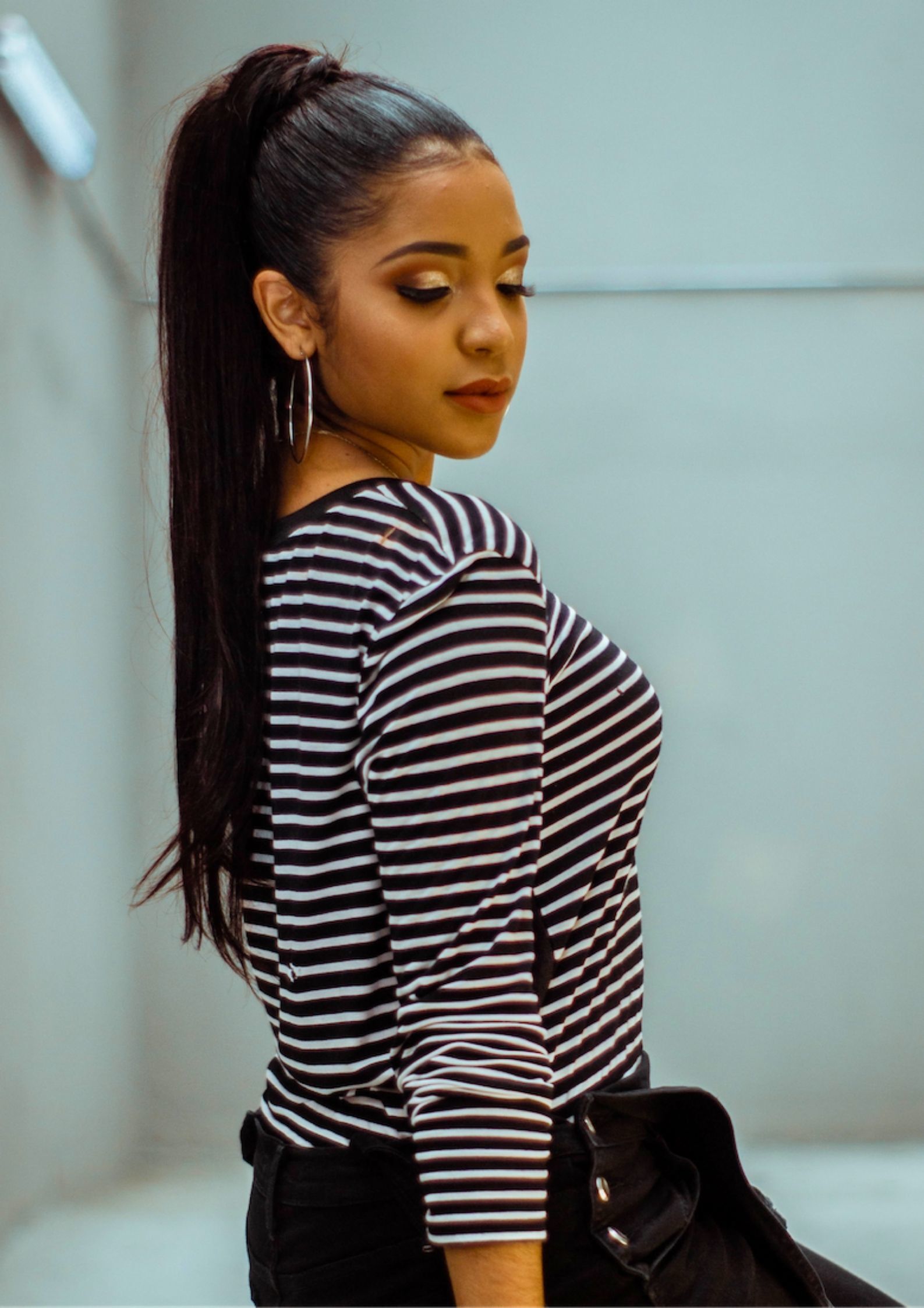 Woman wearing a chic high ponytail for date night