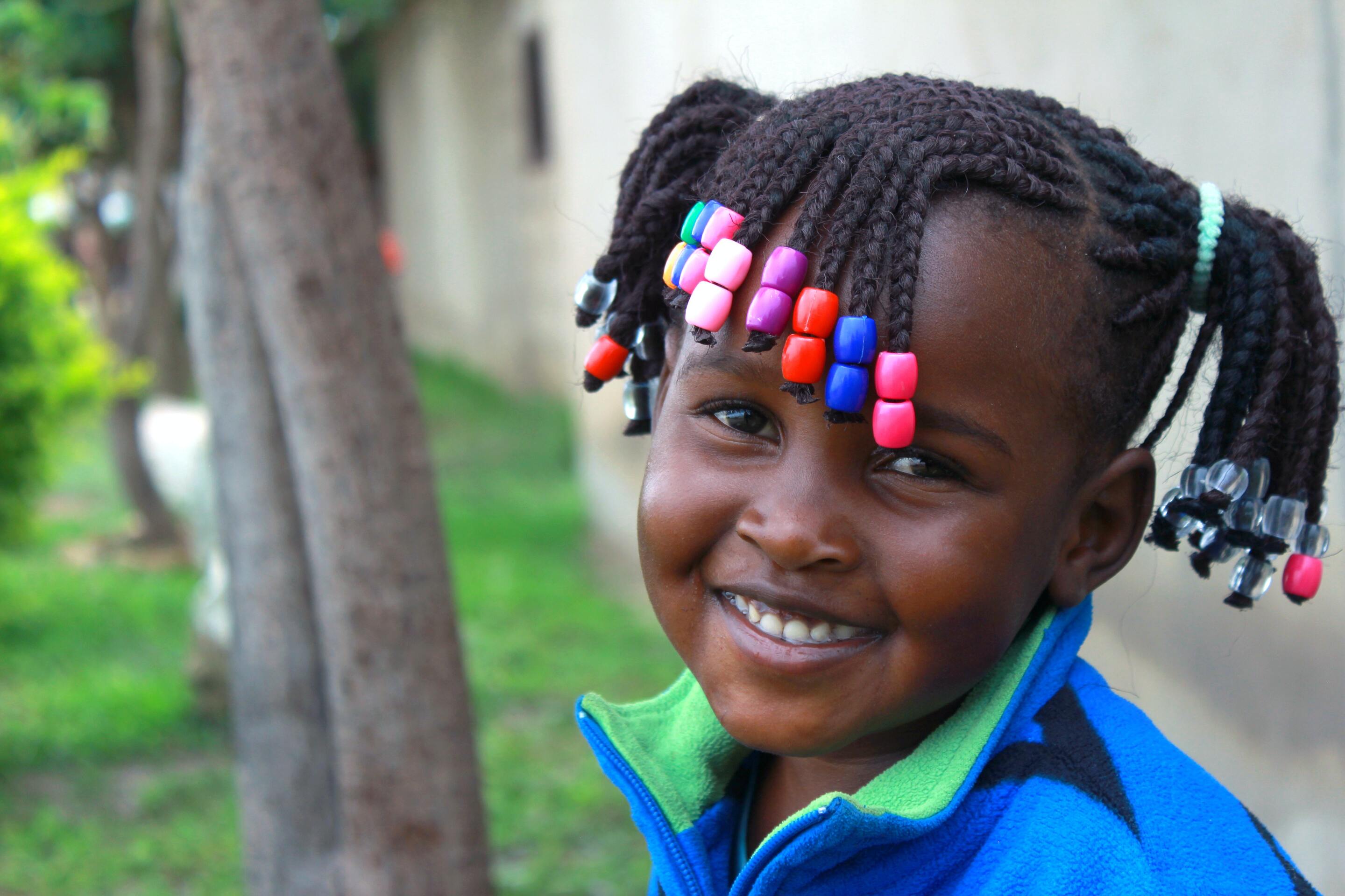 Little girl with braided beads hairstyle