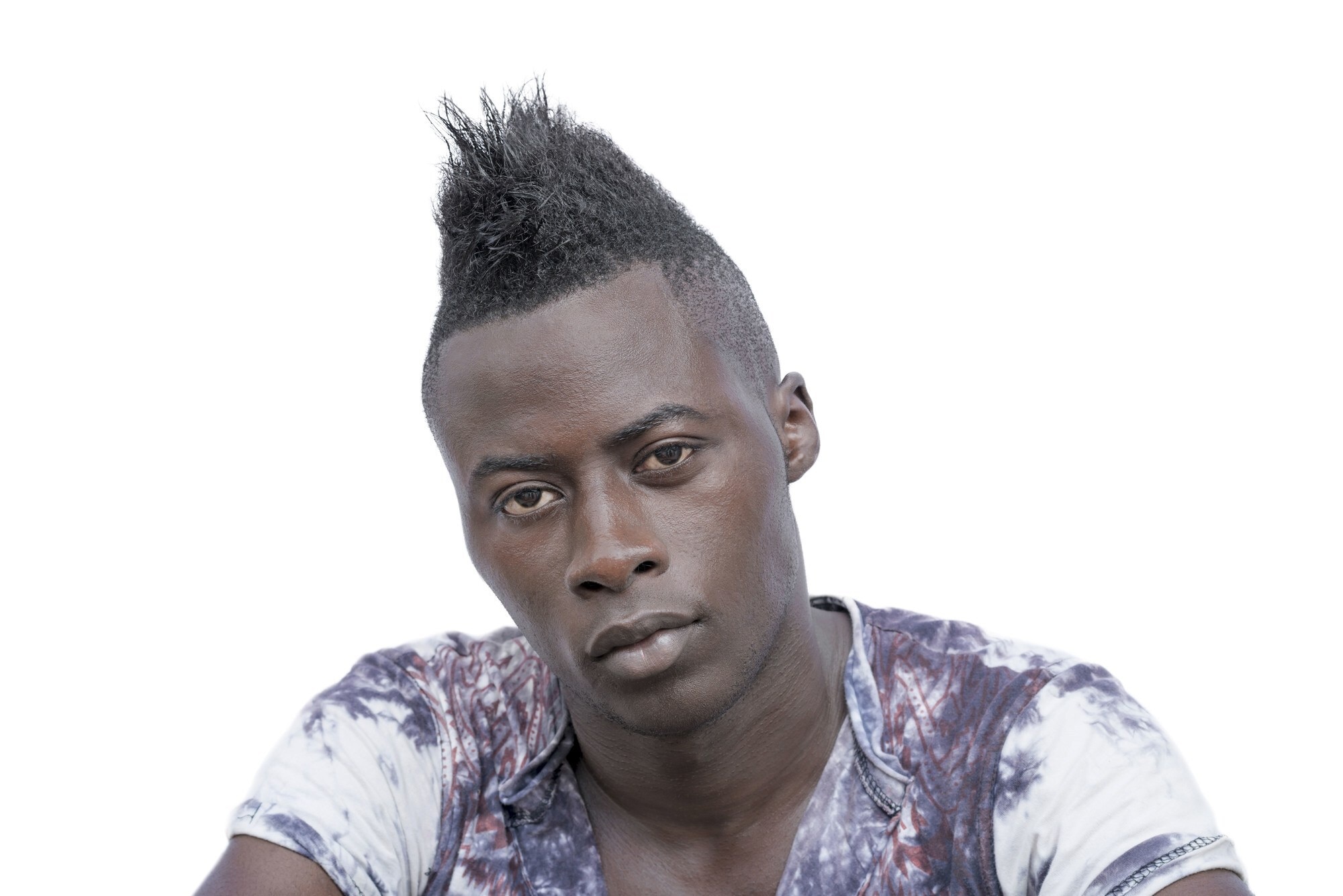 fade haircut: man with a mohawk hairstyle and faded sides