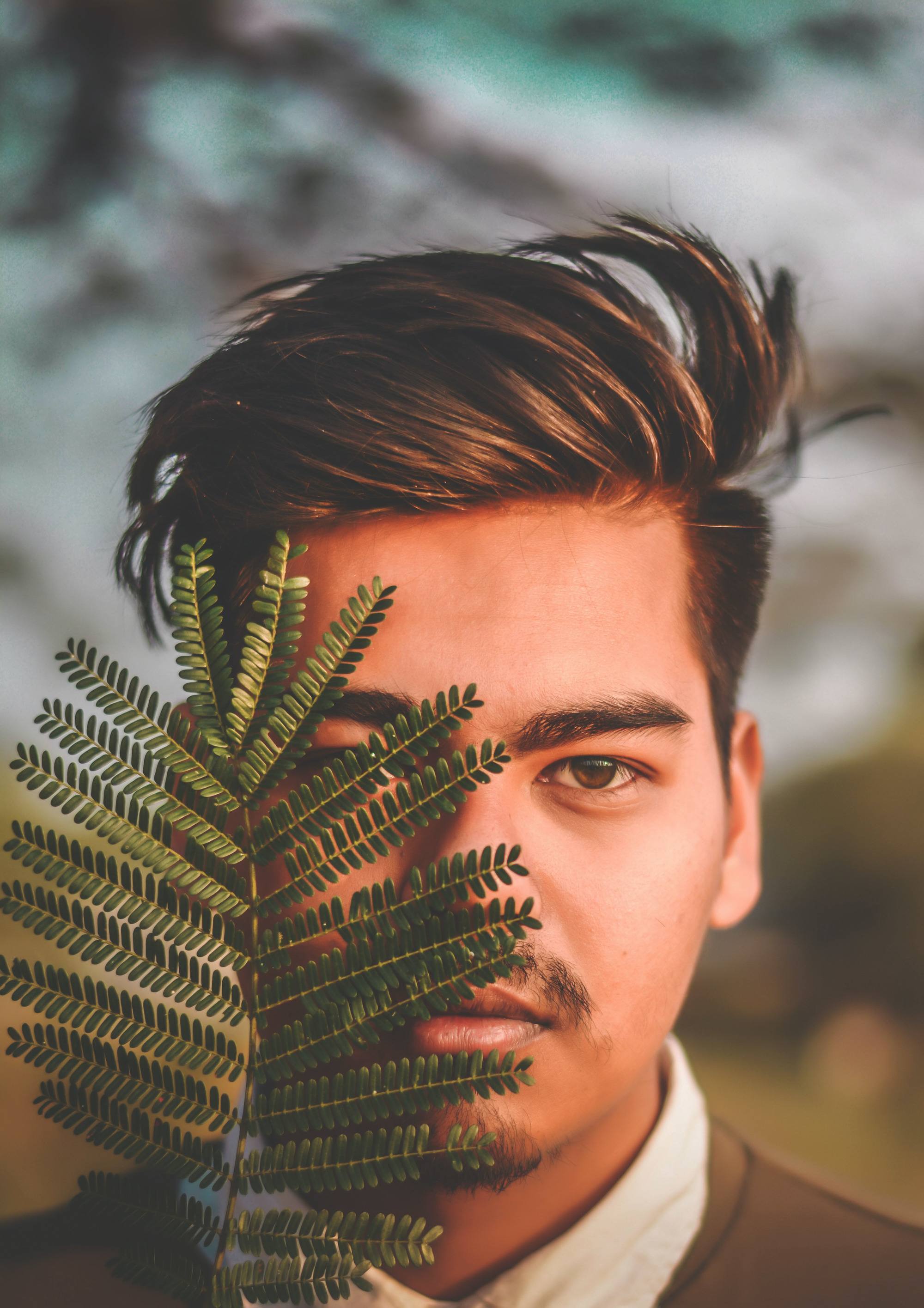 man with tapered fade haircut; medium-length tops; brown hair